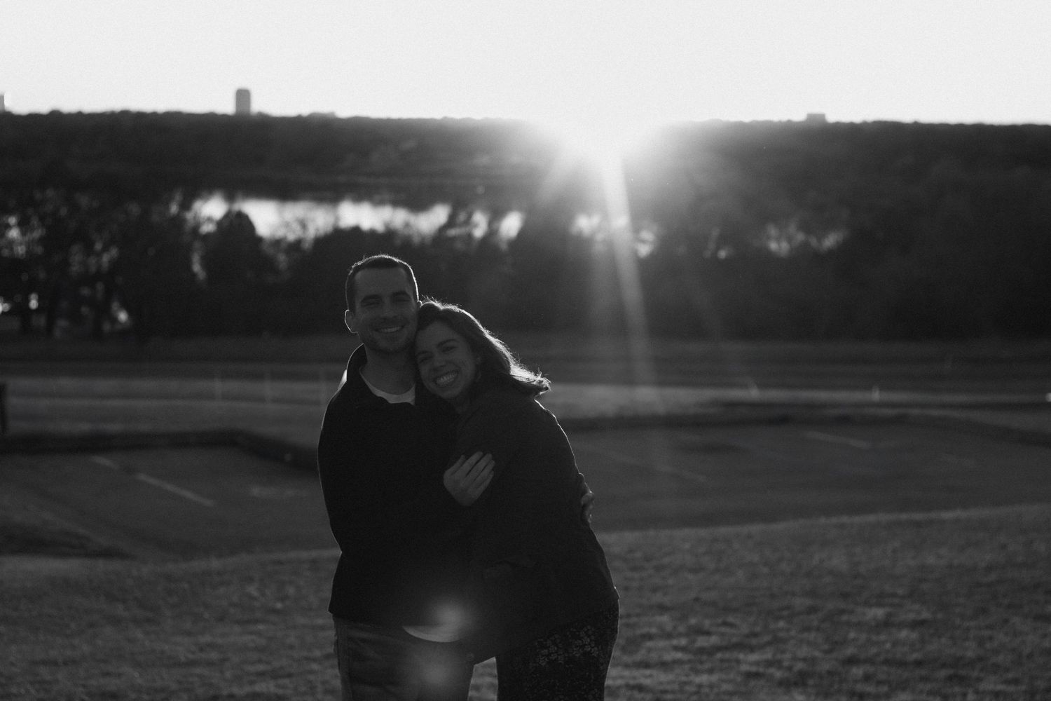 Silhouettes against bright sunset with lens flare creating dramatic backlighting.