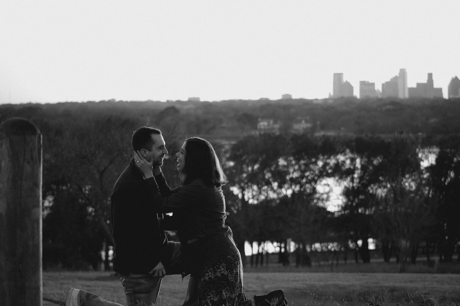 Silhouette of city skyline visible through large windows on wedding day.
