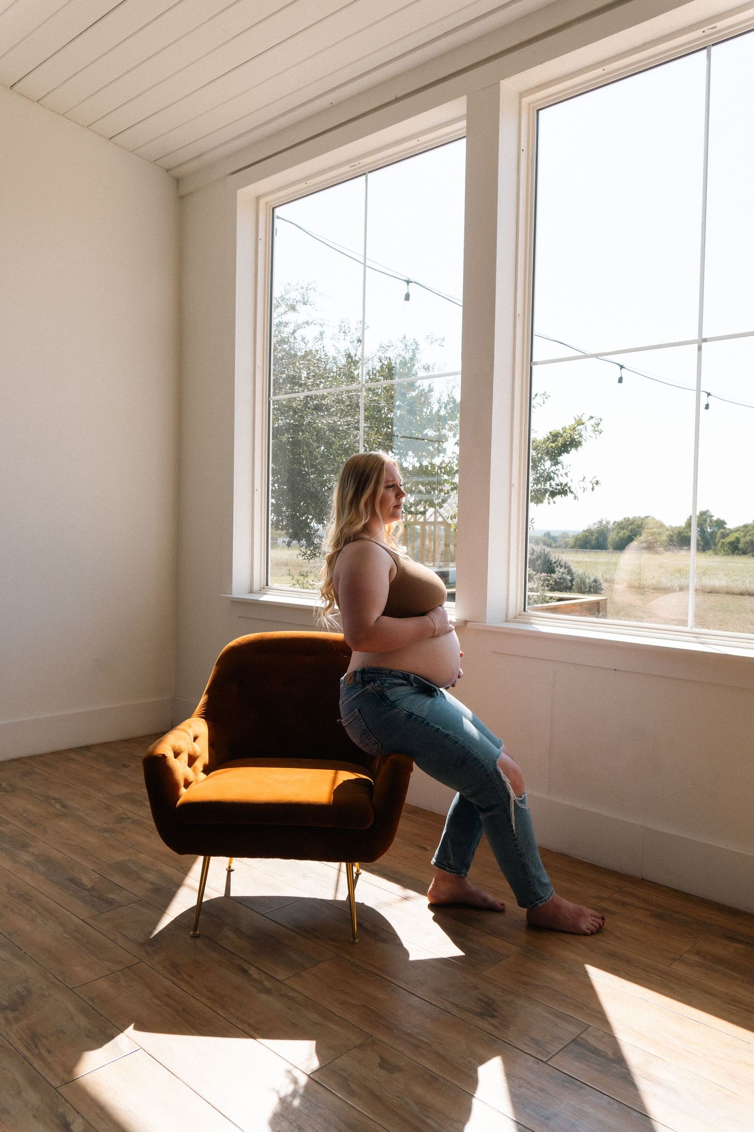 A sequence of photos showing a yellow couch by windows in a sunlit room with hardwood floors, capturing different viewing angles.