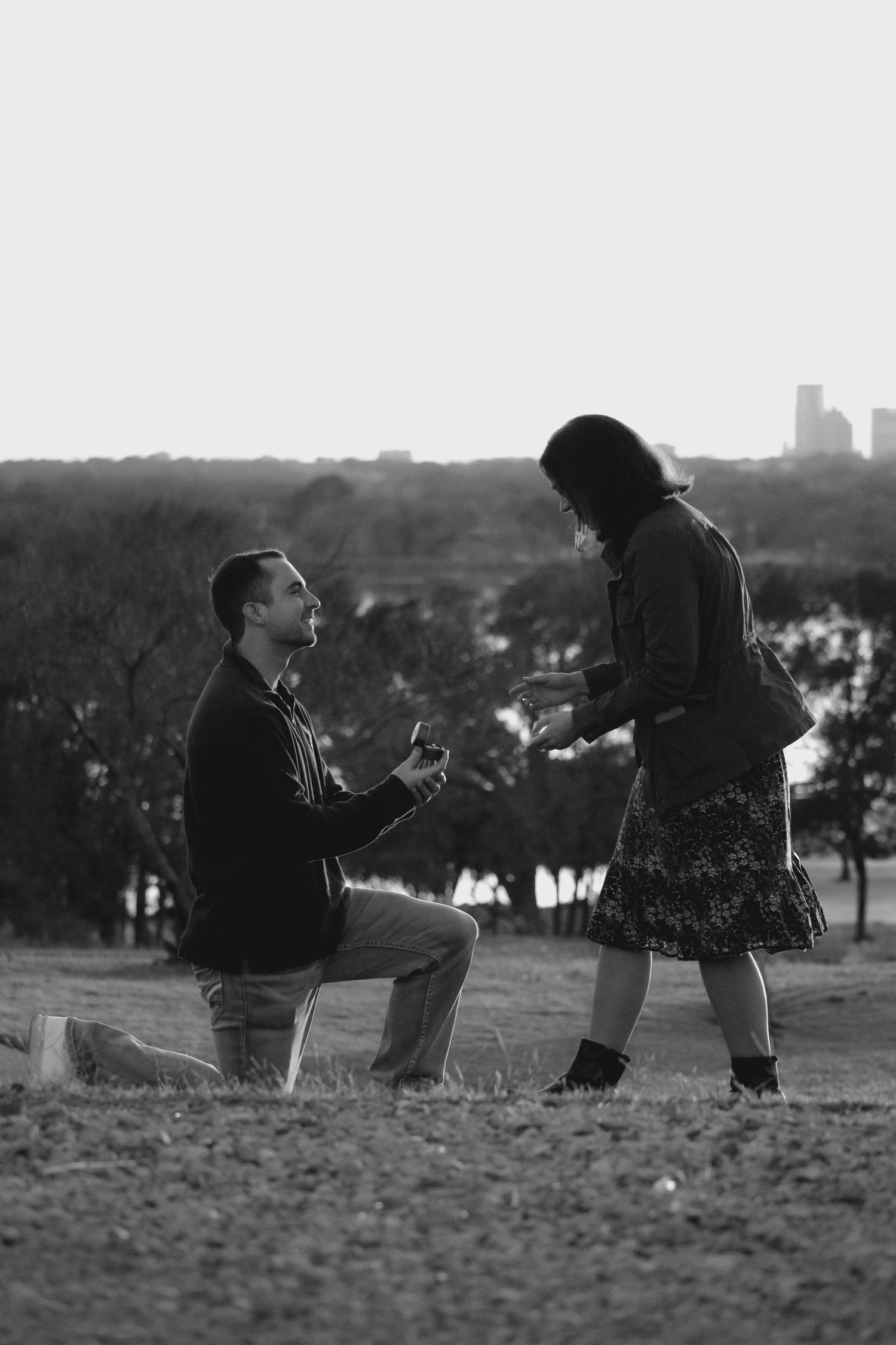 Proposal moment captured in sequence showing silhouettes against city skyline.