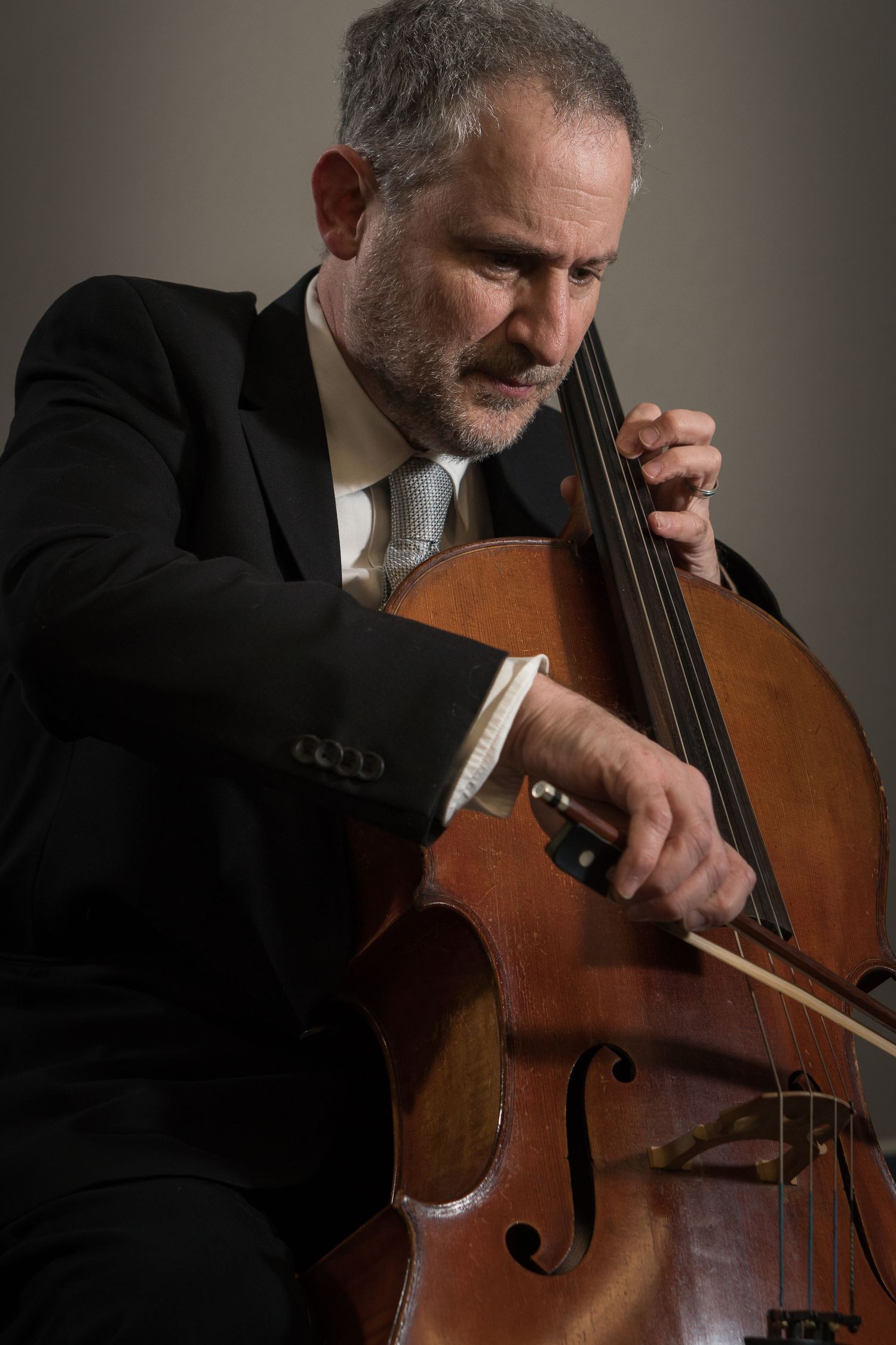 Male cellist playing the cello