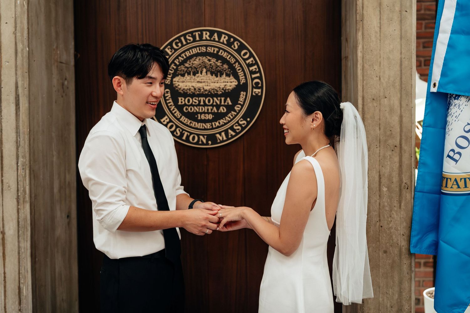A couple dances playfully in a formal setting with flags and a government seal visible.