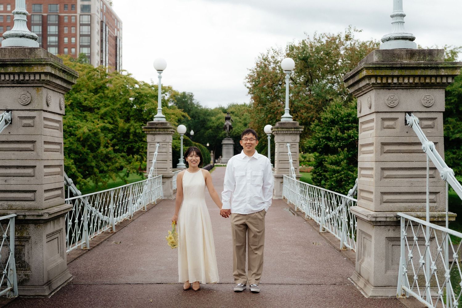 Boston Public Garden engagement photo with the couple on the bridge