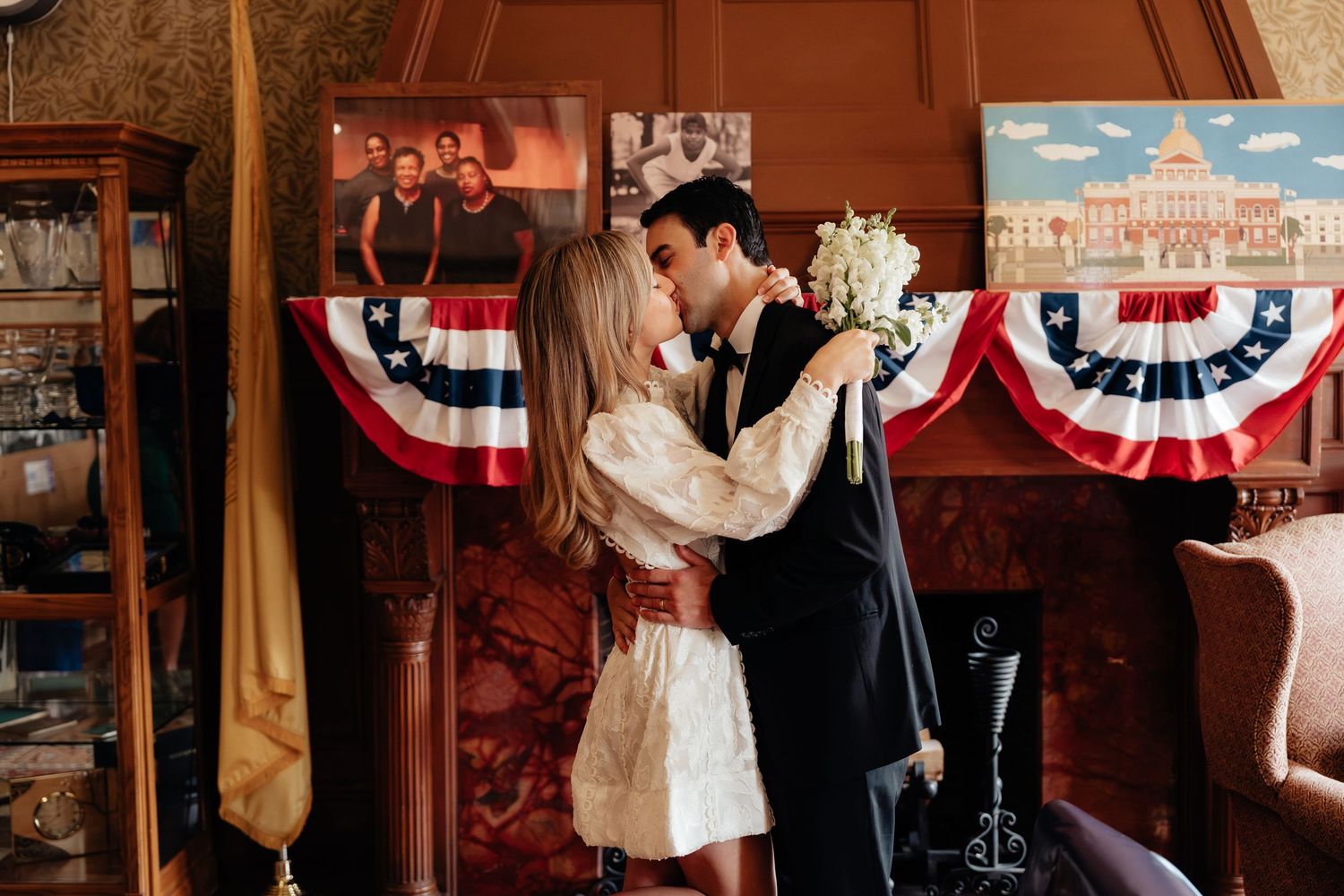 Couple sharing a romantic dance moment in a room decorated with patriotic bunting.