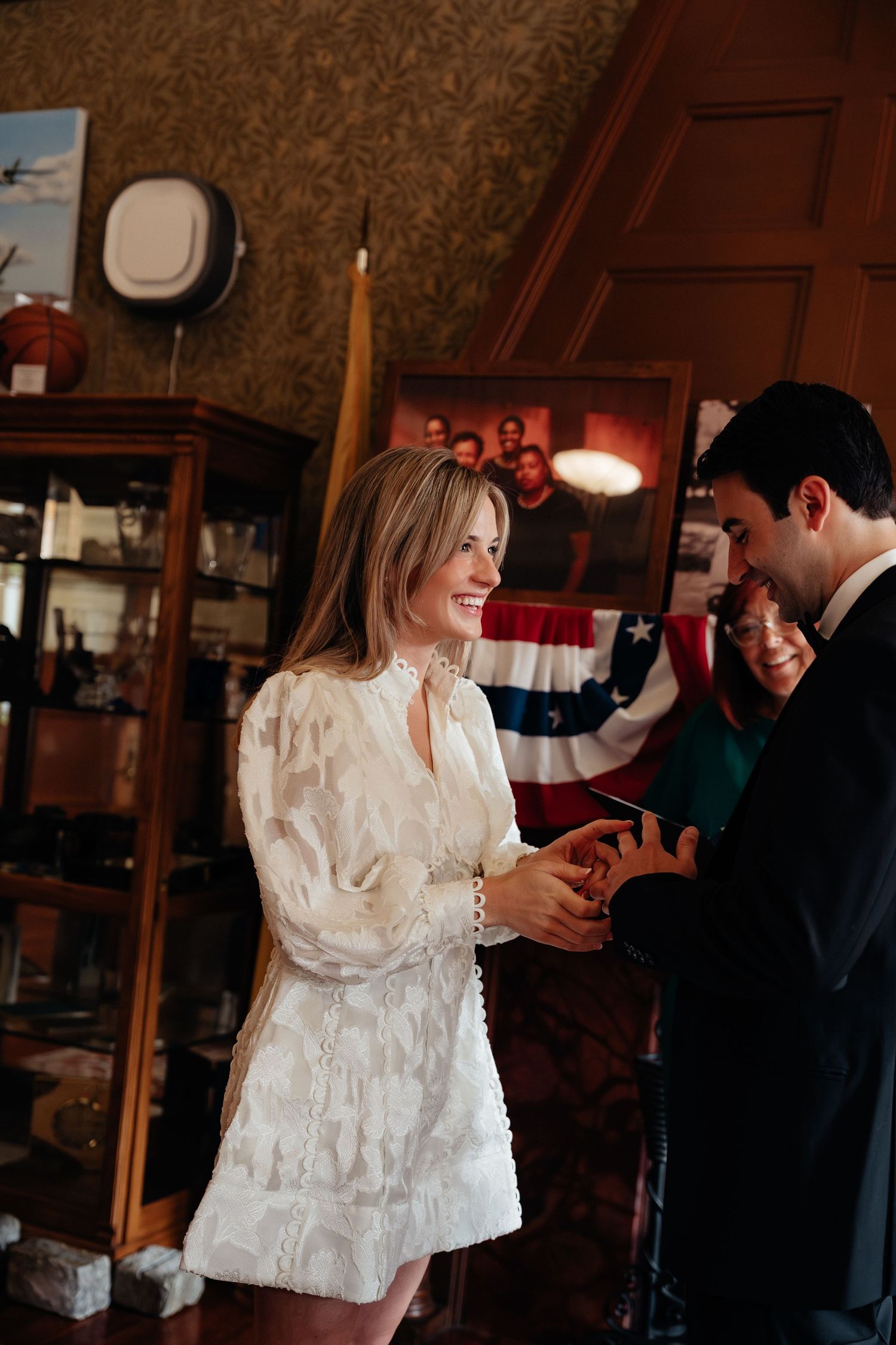 Couple dancing together in an intimate indoor setting with warm lighting and vintage decor.