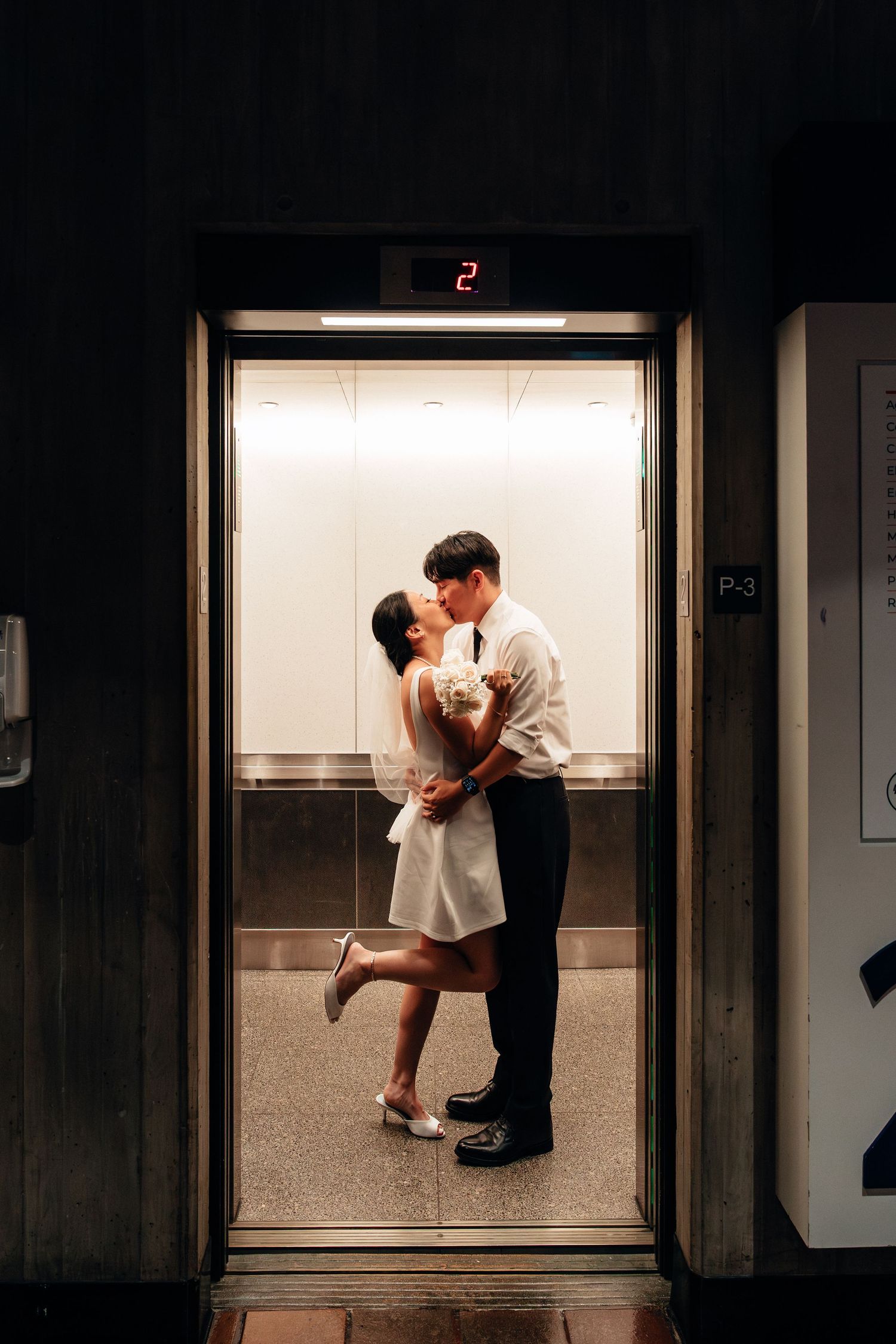 A romantic elevator photoshoot sequence with dramatic lighting and intimate poses.