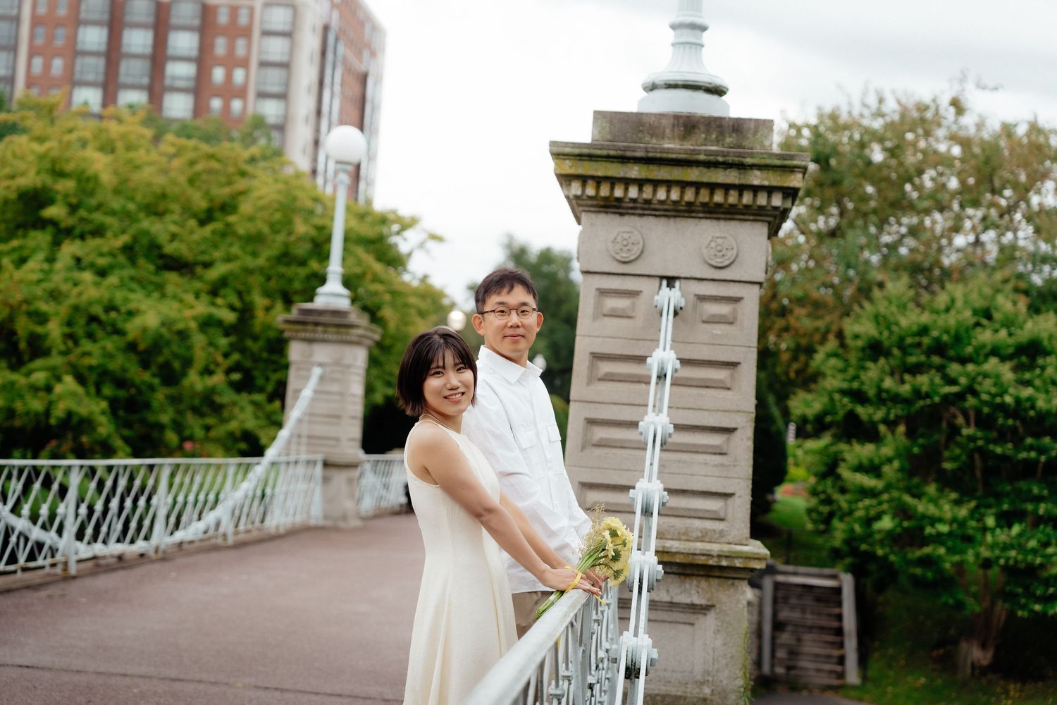 Boston Public Garden engagement photo with the couple on the bridge