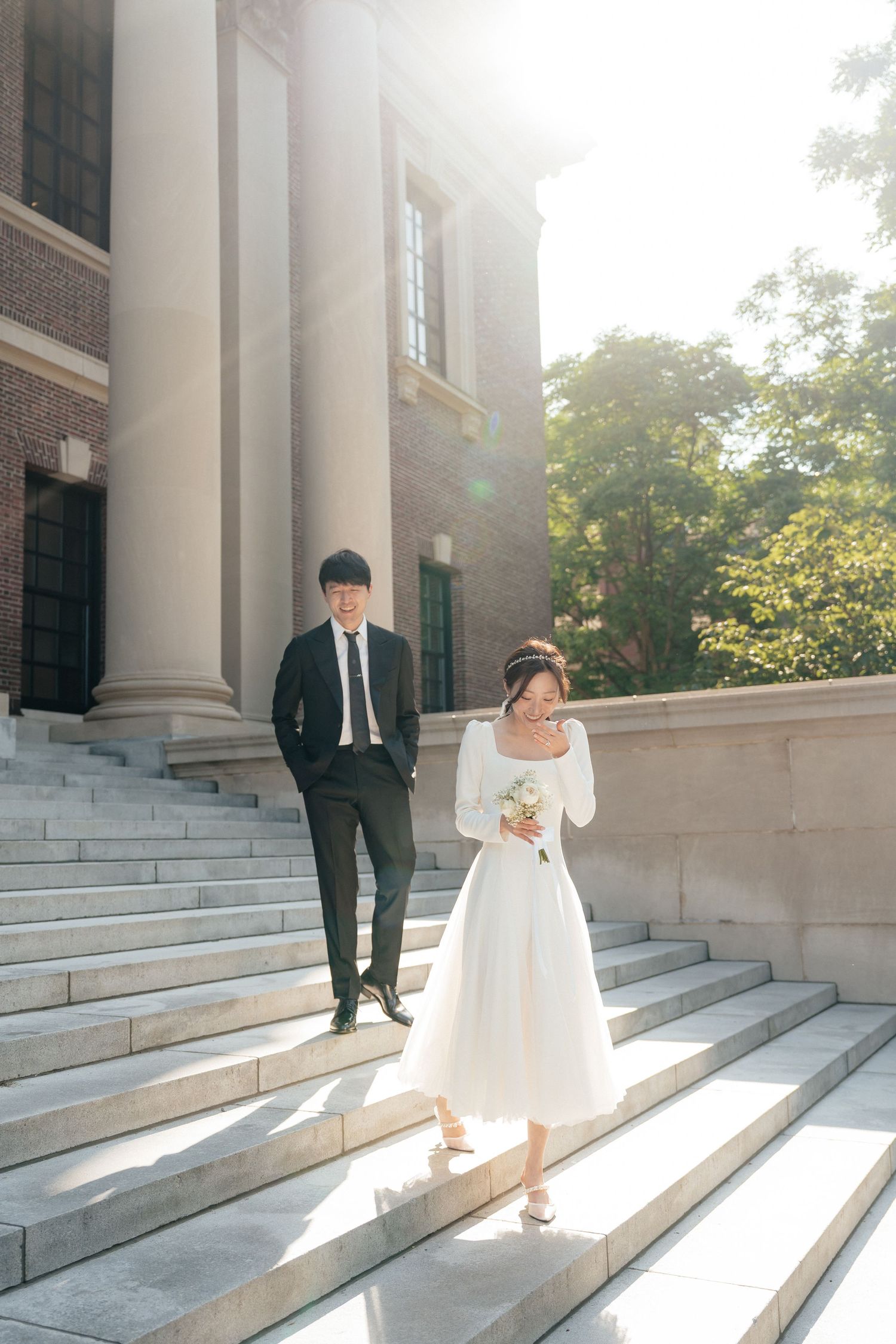 A romantic photo sequence on grand marble steps with dramatic sunlight and classical columns.