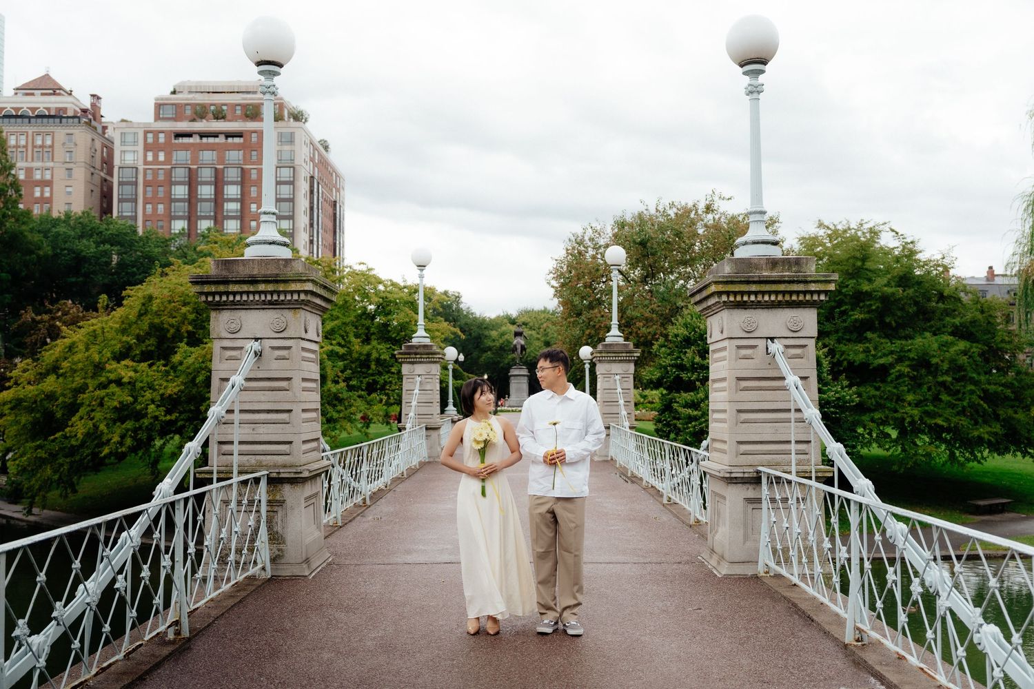 Boston Public Garden engagement photo with the couple on the bridge