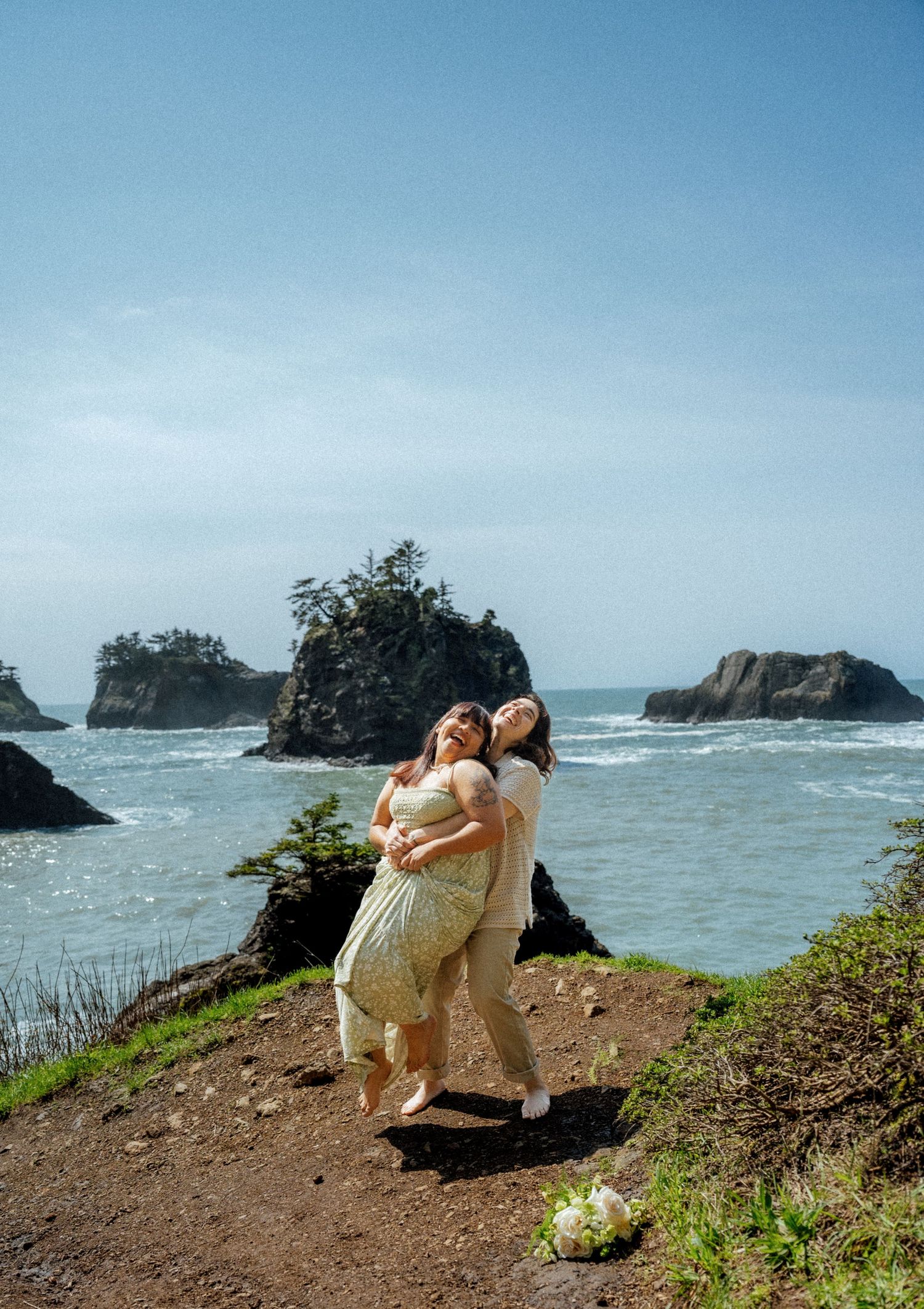 Coastal photography session on cliff edge overlooking dramatic ocean views.