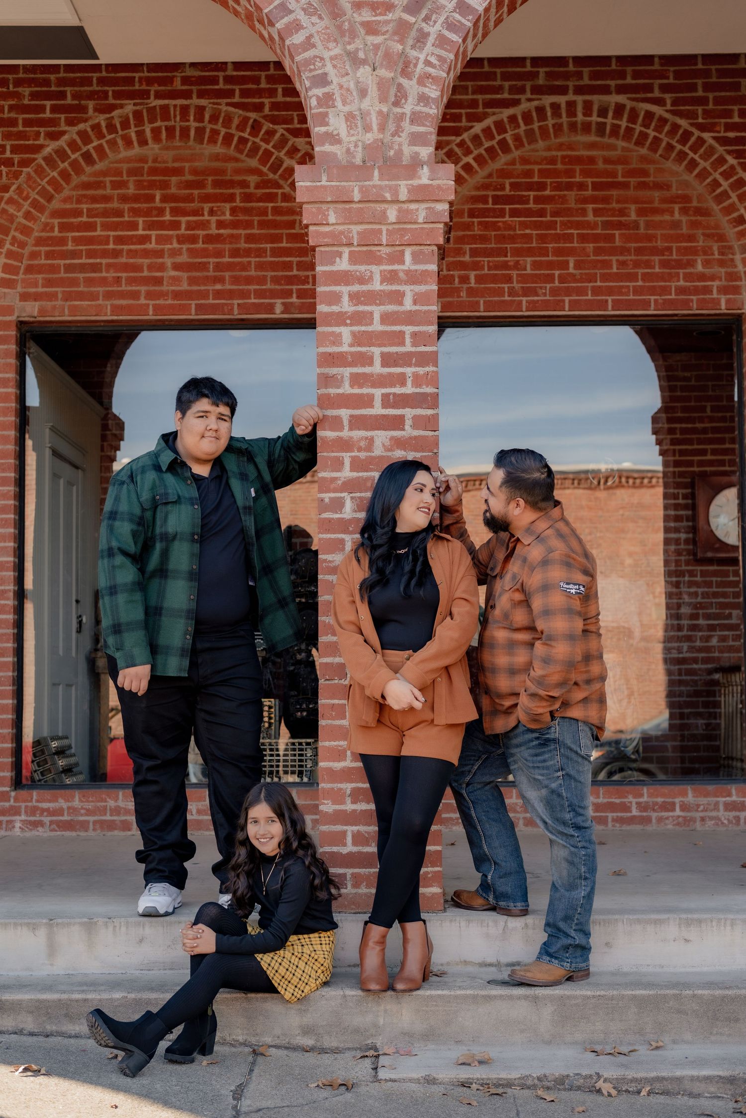 Playful photo sequence showing people posing under brick archways in casual clothing.