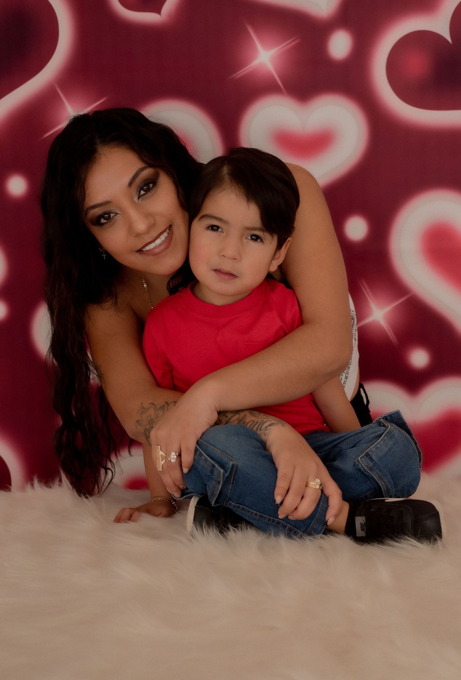 Valentine's themed photoshoot with heart background and warm lighting effects.
