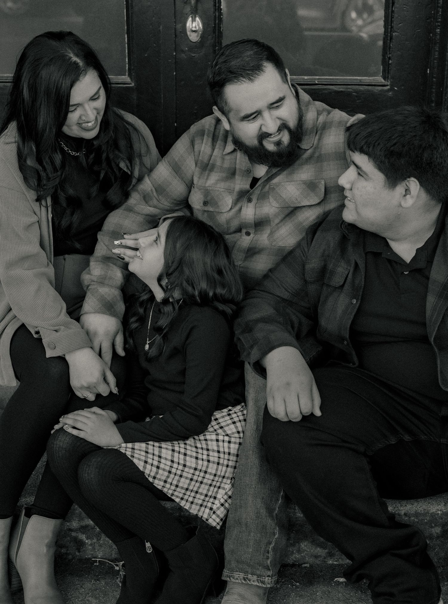 Black and white photo series of people laughing and enjoying a casual moment together.