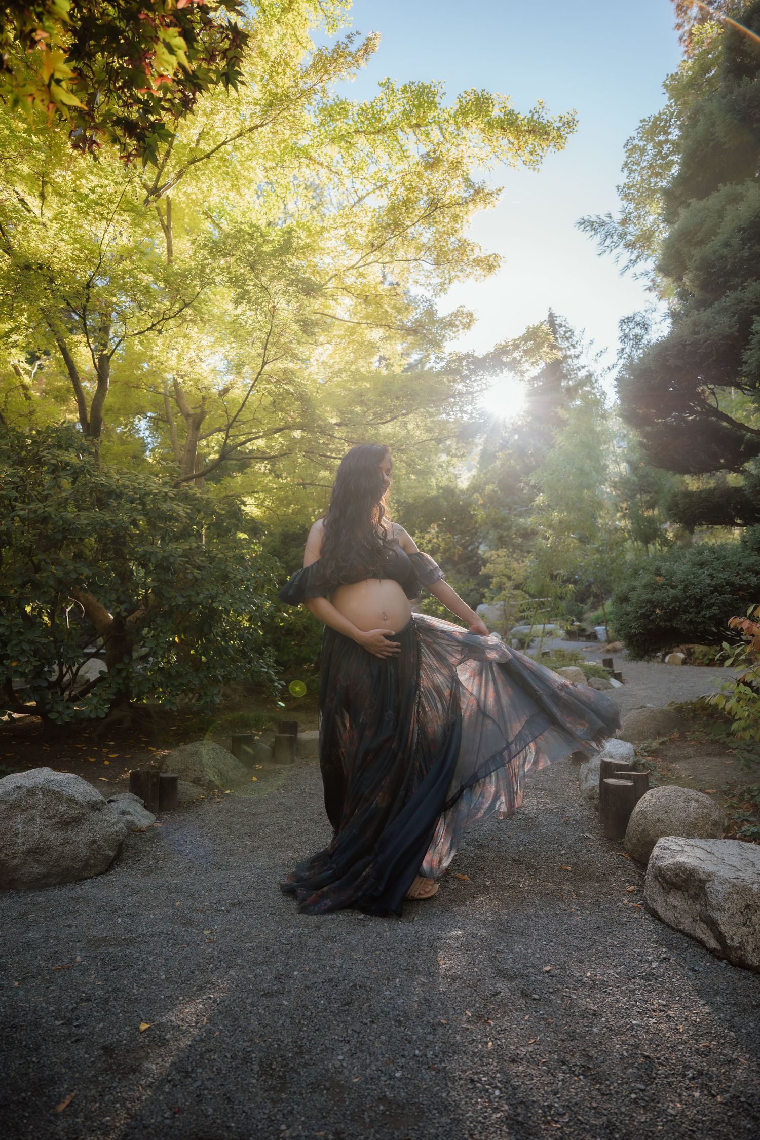Dreamy outdoor portrait with golden sunlight filtering through autumn trees.