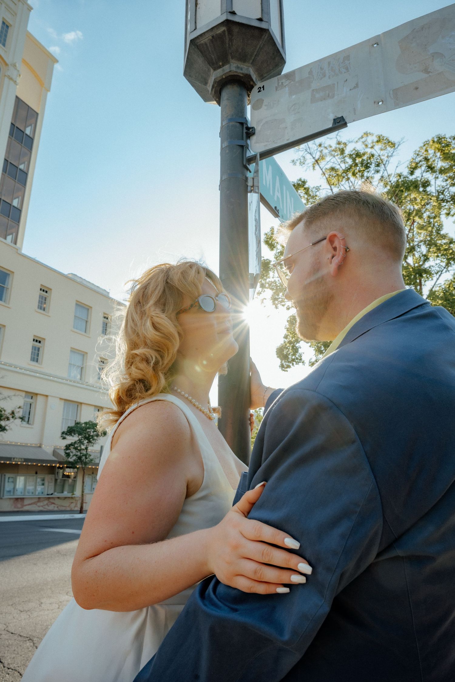 Sunlit moments shared outside a historic white building.