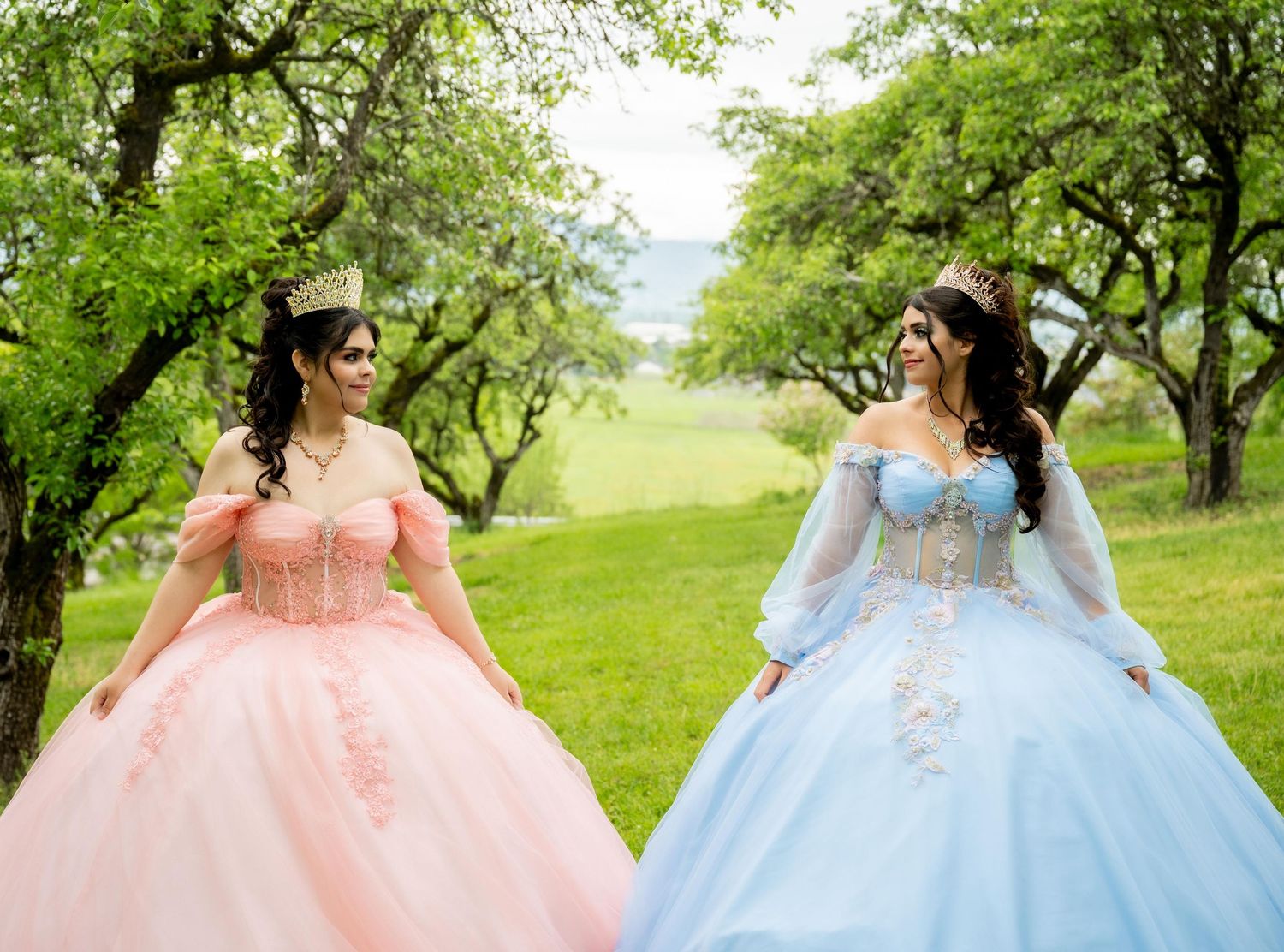 Outdoor photo series of flowing ballgowns in pink and blue against green spring landscape.