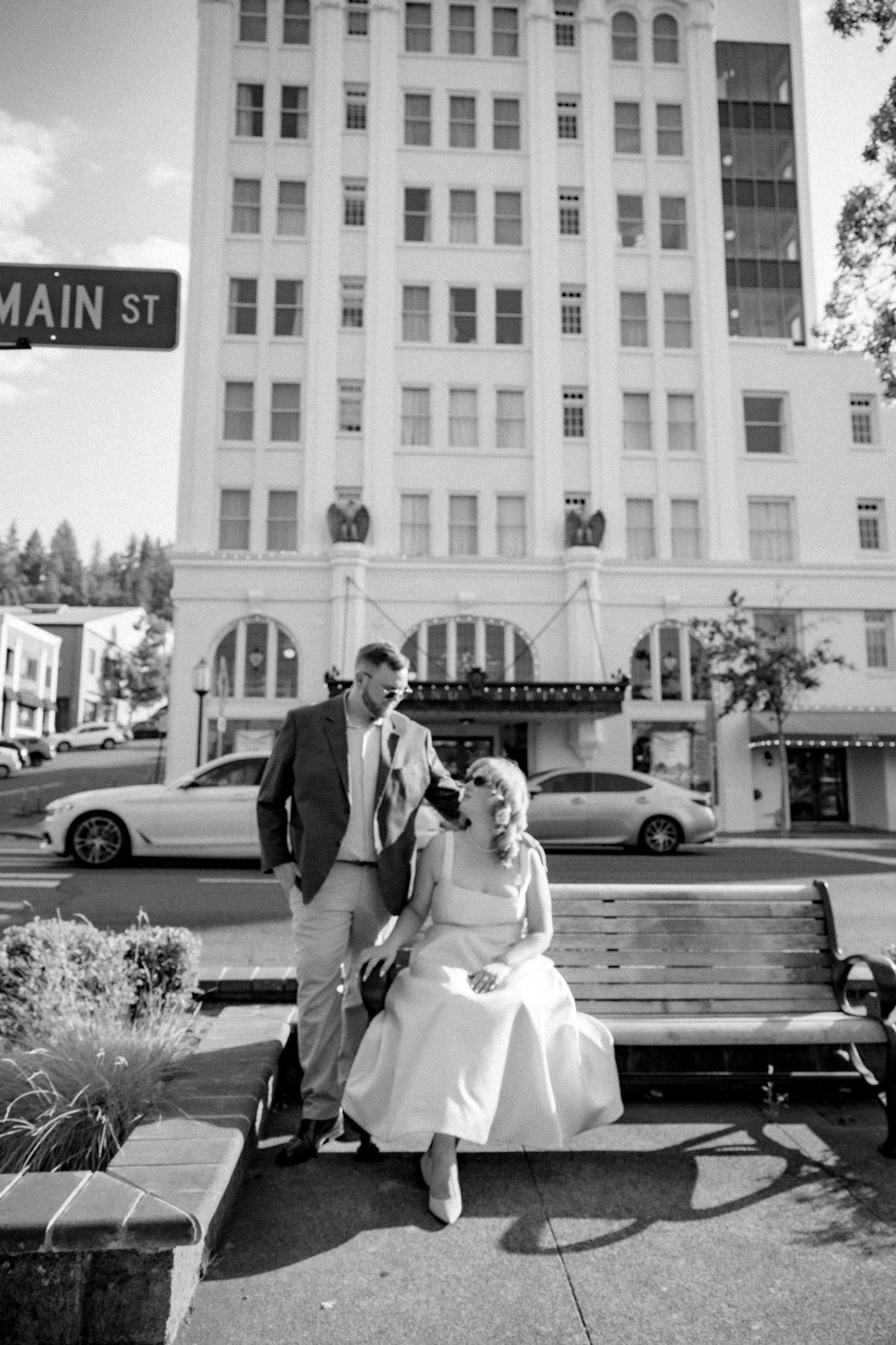 A series of romantic moments captured outside a historic Main Street building.