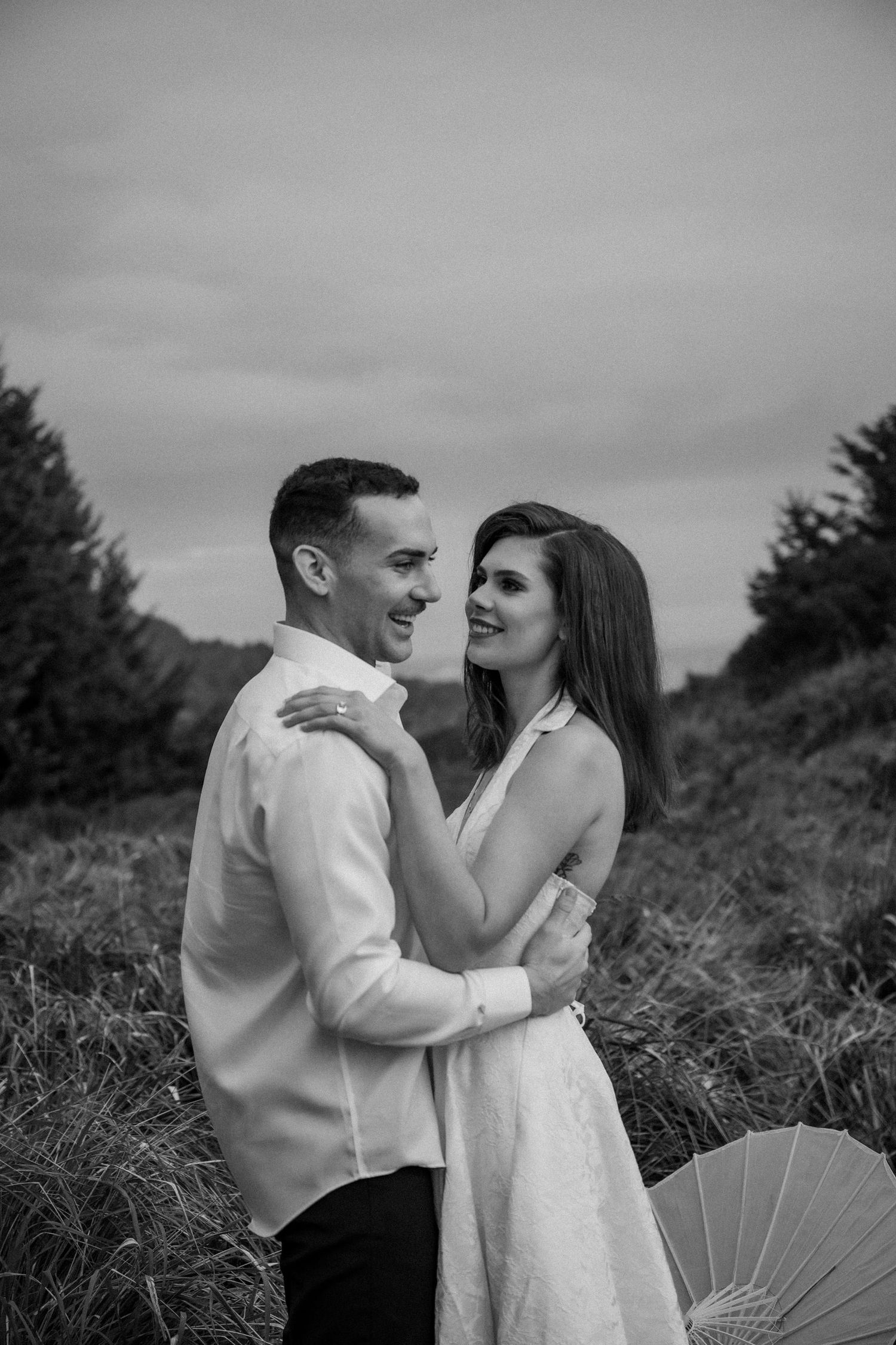 Intimate black and white portraits of a couple embracing outdoors.