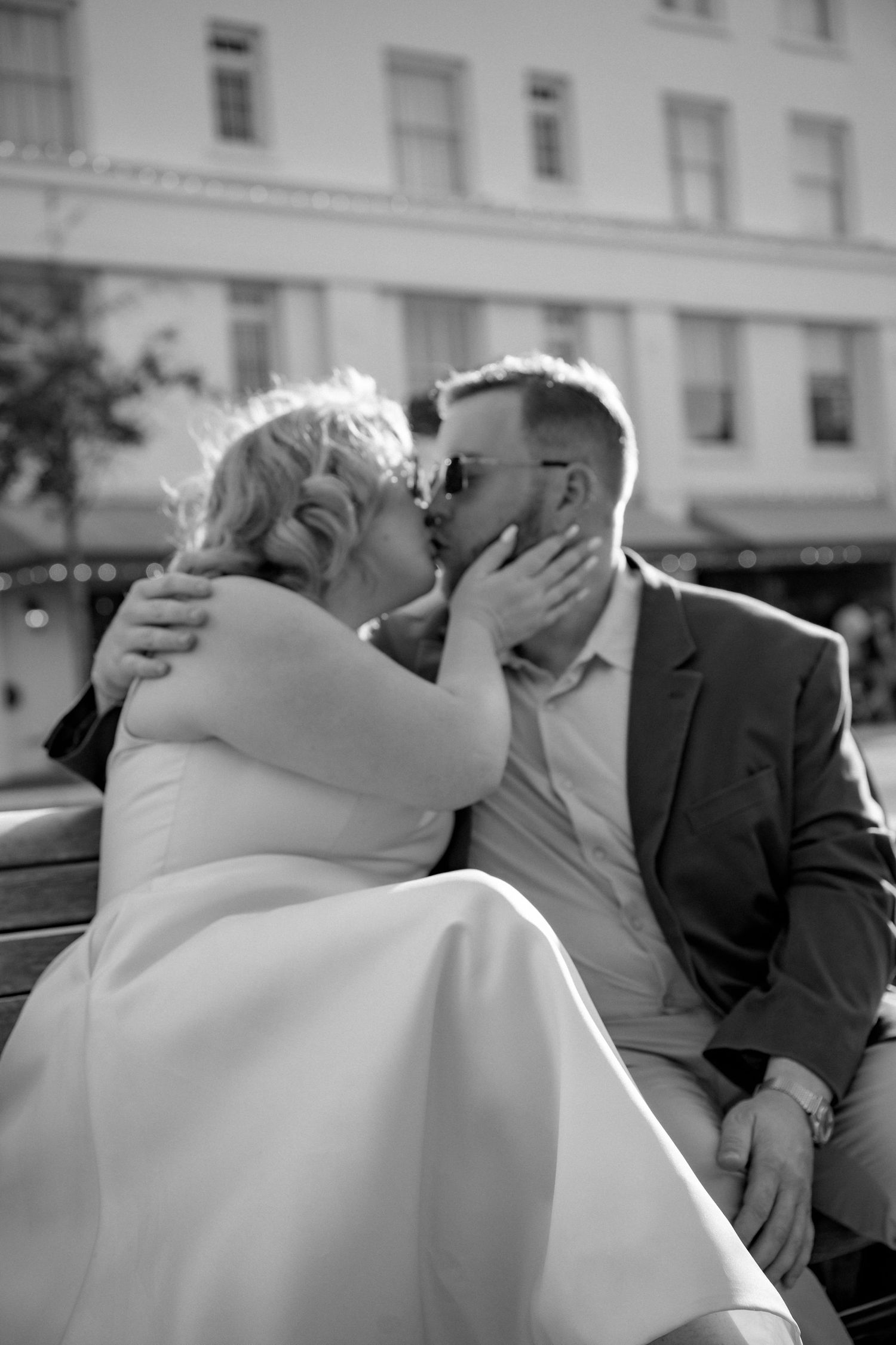 Black and white series of intimate moments shared on a bench.
