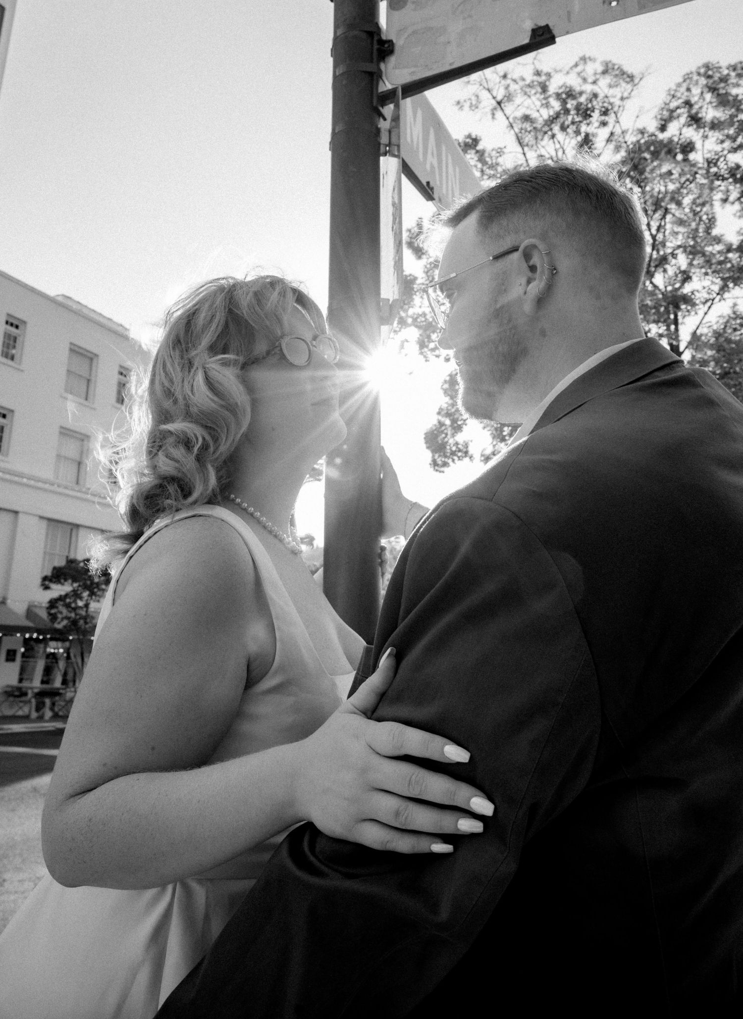 Series of romantic black and white photos capturing a couple's tender moment in sunlight.