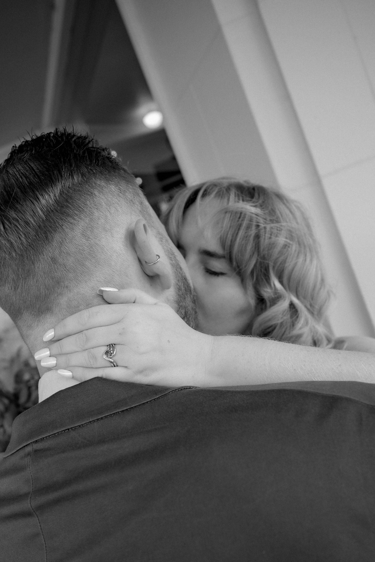 Black and white close-up photos of a romantic couple kissing in sequence.
