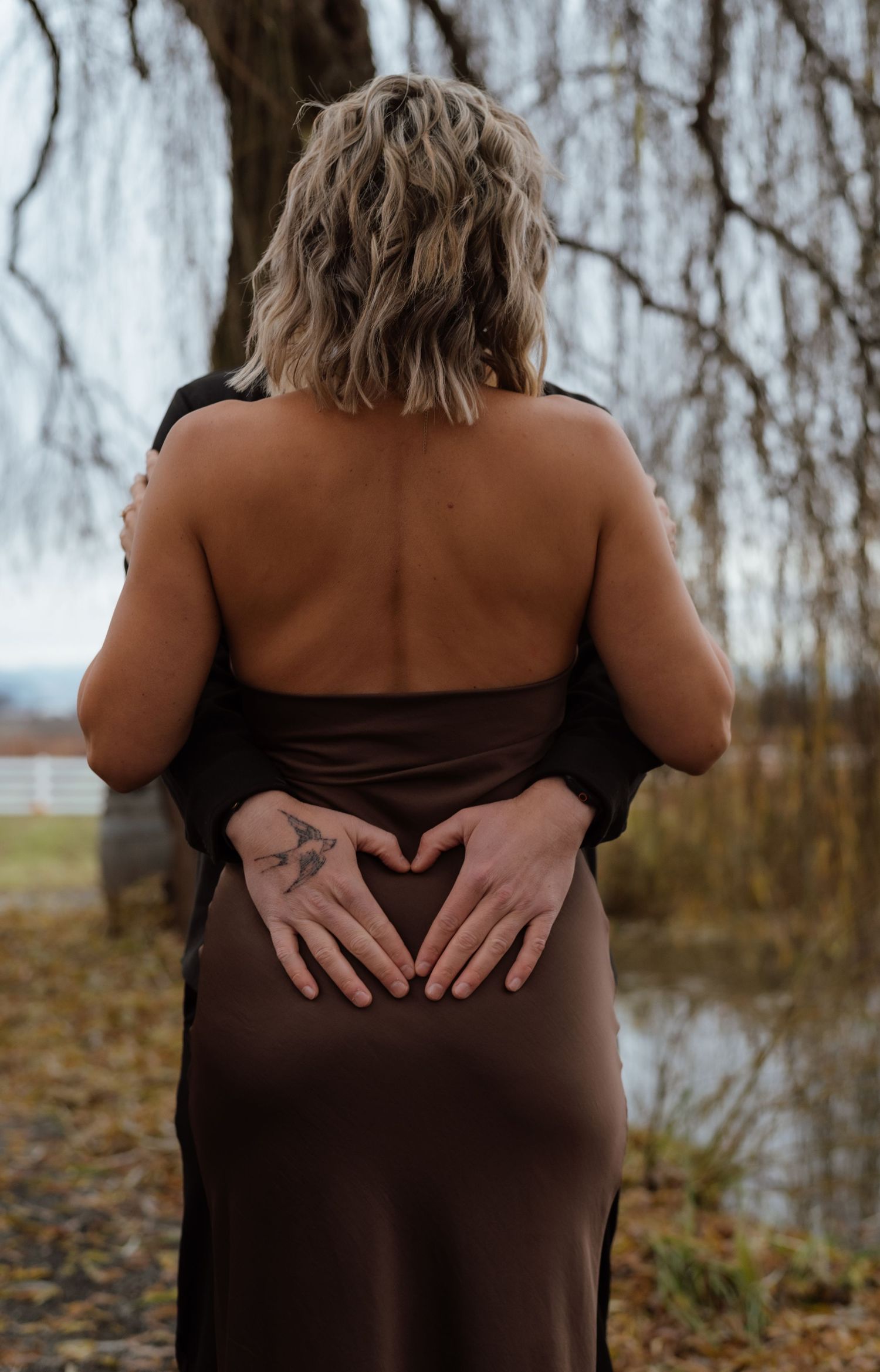 A series of artistic maternity photos showing hands forming heart shapes on a brown dress against an autumn backdrop.