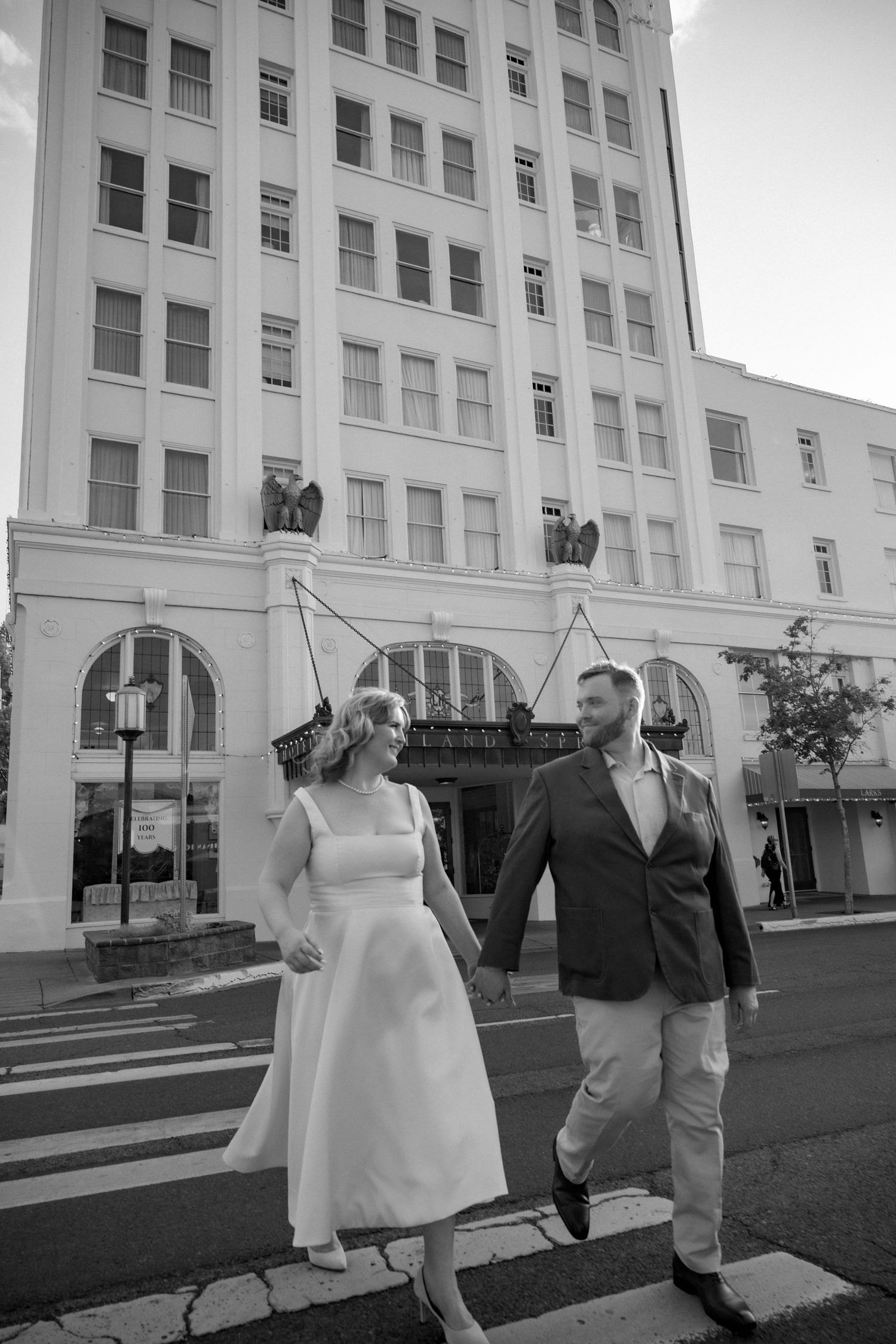 Black and white series showing movement and interaction outside a historic building.