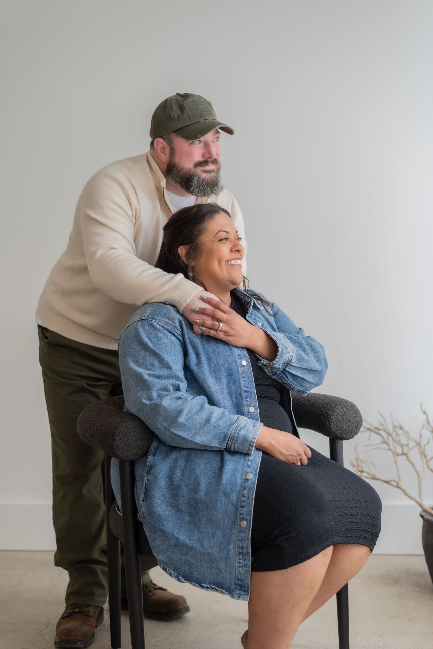 A tender moment captured between a couple in a bright studio setting.