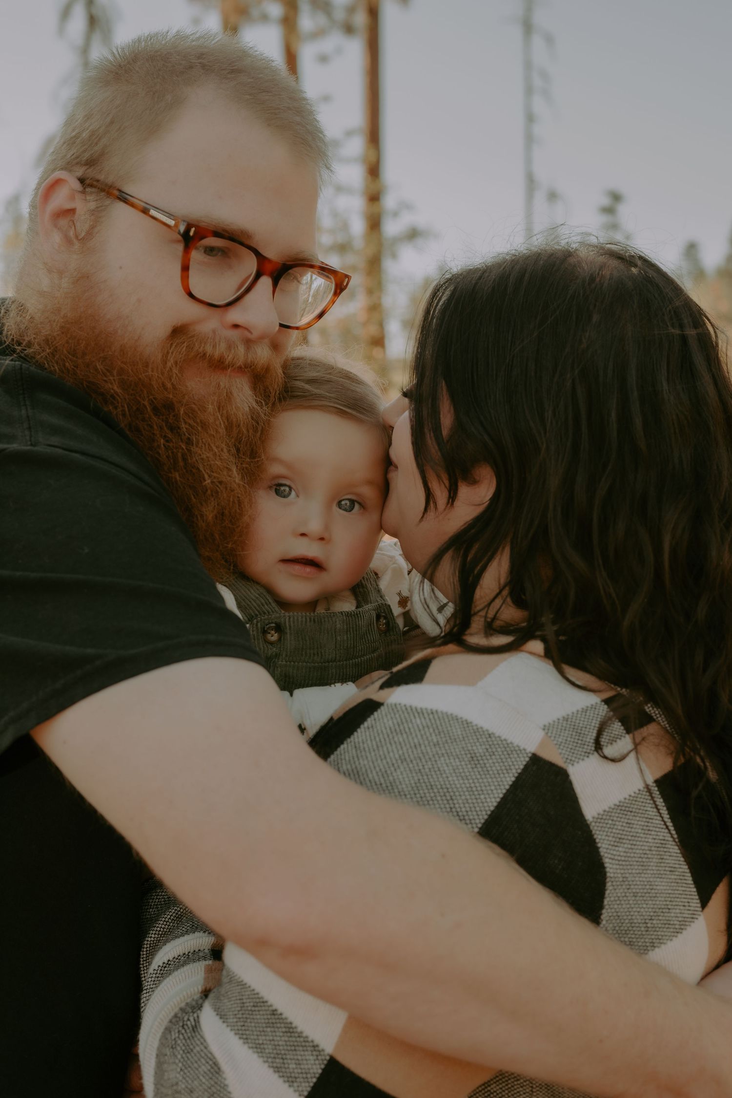 Tender family embrace photographed in warm golden hour lighting.