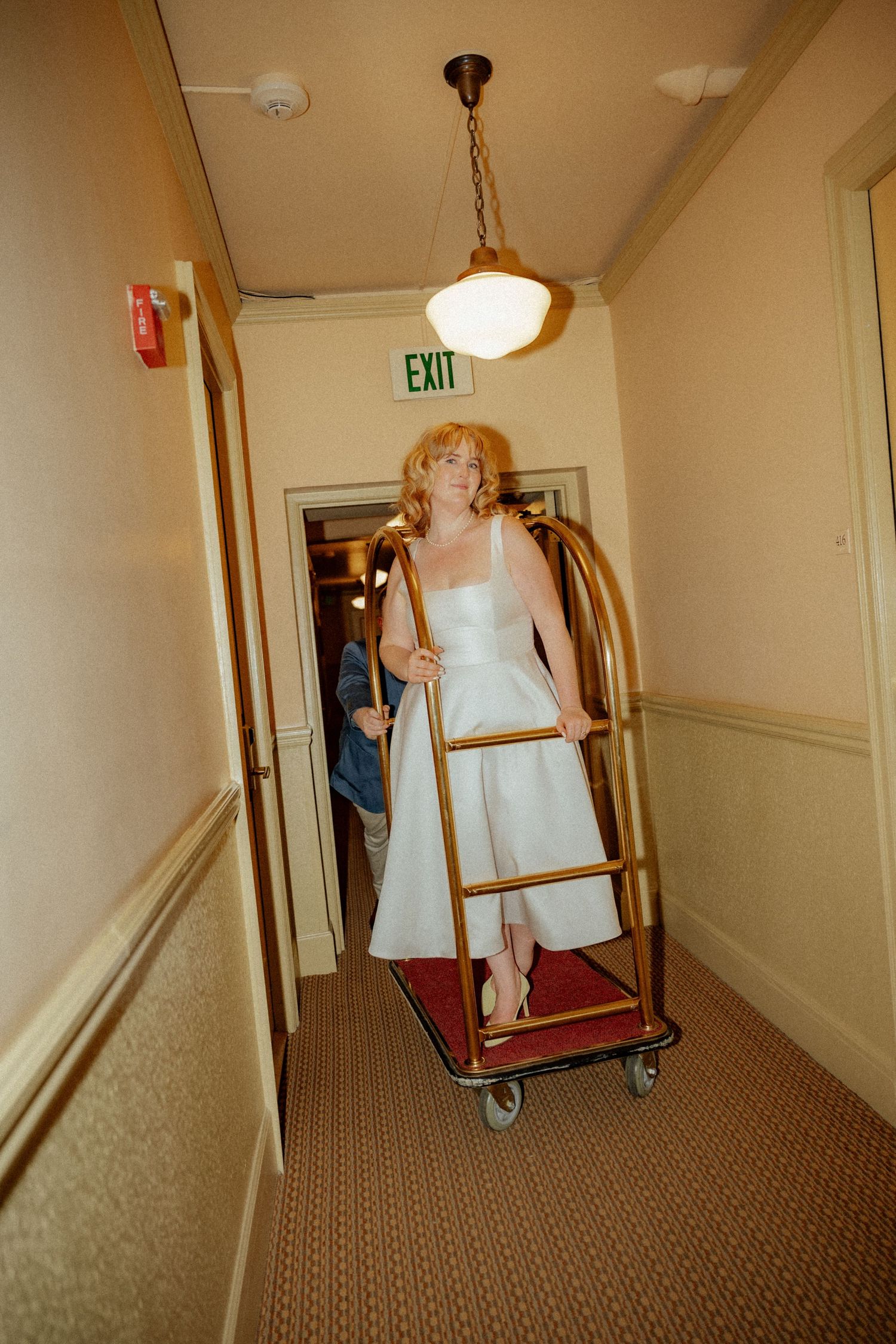 A sequence showing movement through a vintage hotel hallway with carpeted floors.