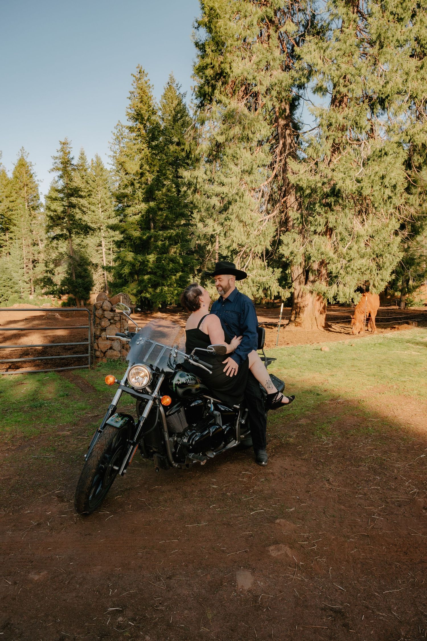 A motorcycle photoshoot in a forest clearing during golden hour.