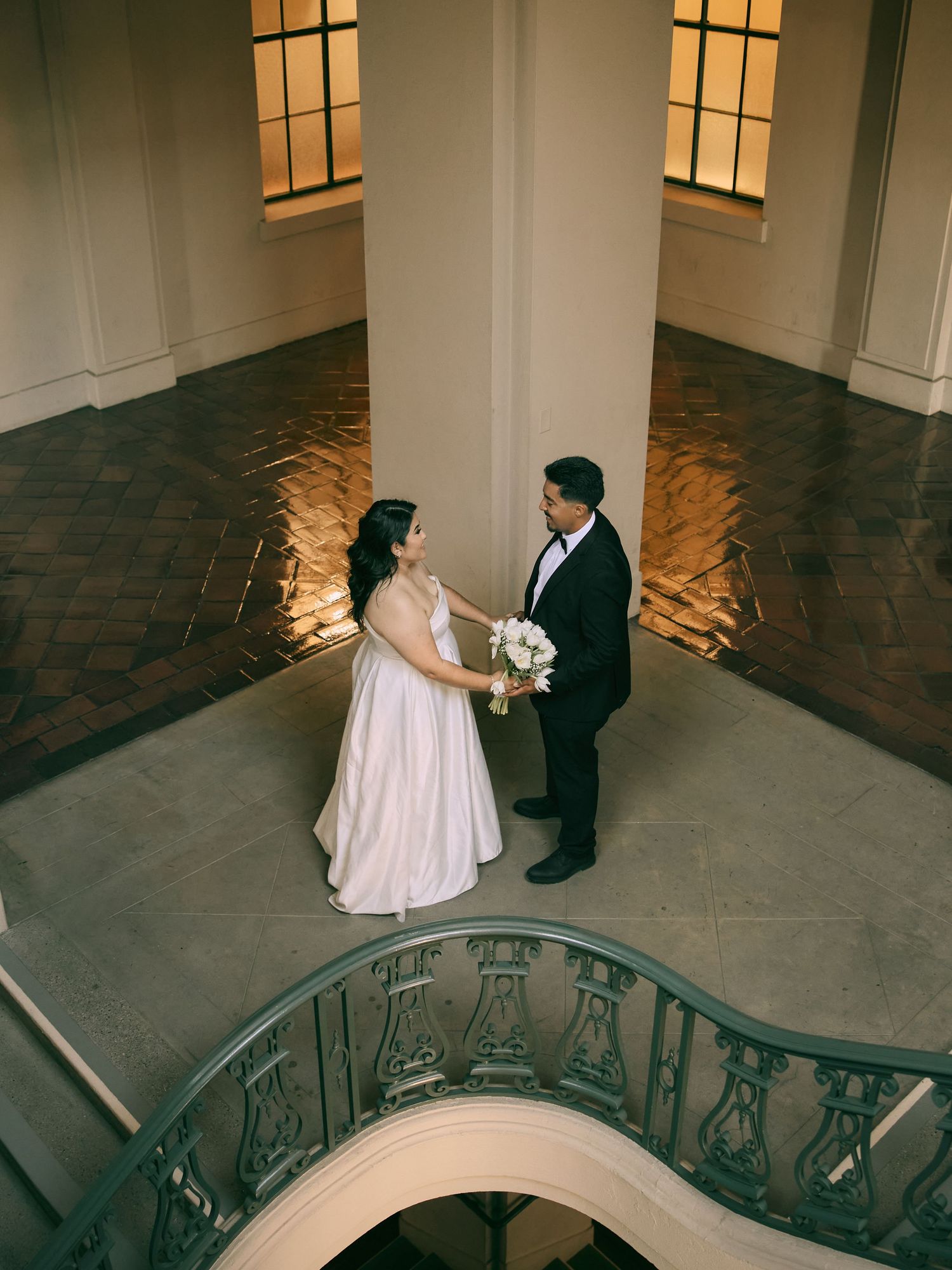 Romantic wedding portraits under classic arches at Pasadena City Hall by Southern California wedding photographer.