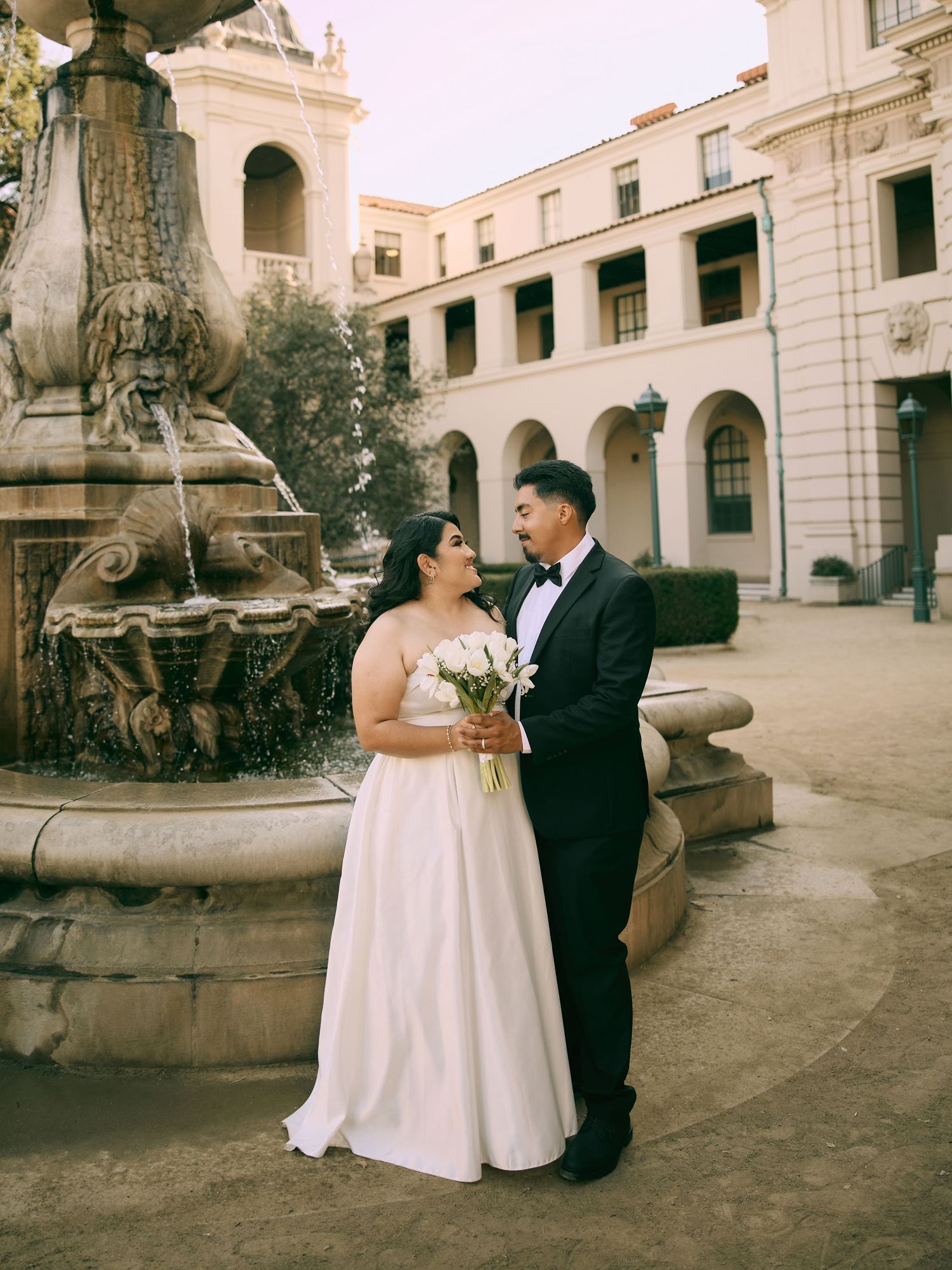 Romantic wedding portraits by central courtyard fountain at Pasadena City Hall by local wedding photographer.