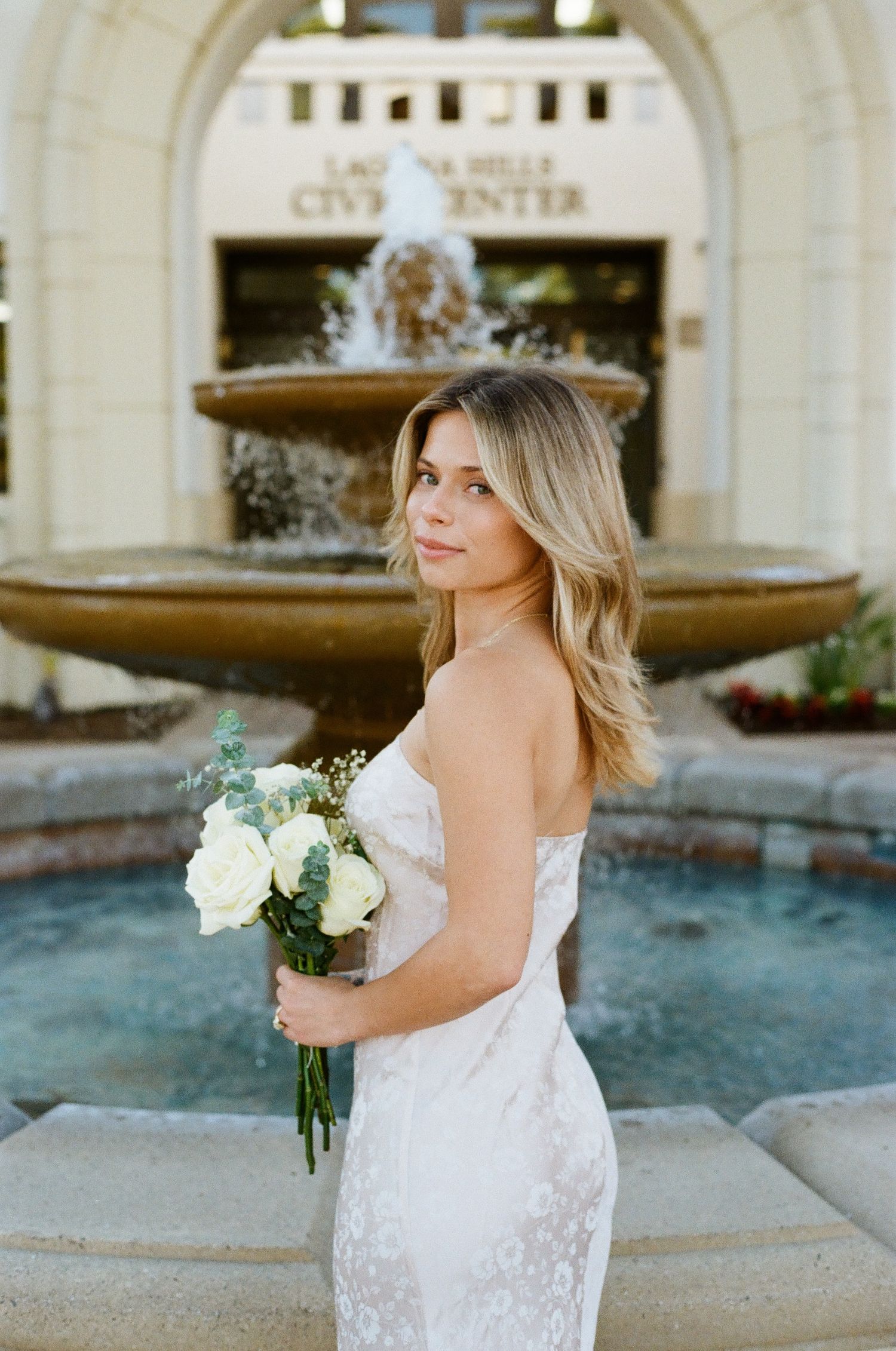 Bridal portrait of a woman in a white dress holding a bouquet at an elegant Los Angeles area elopement location.
