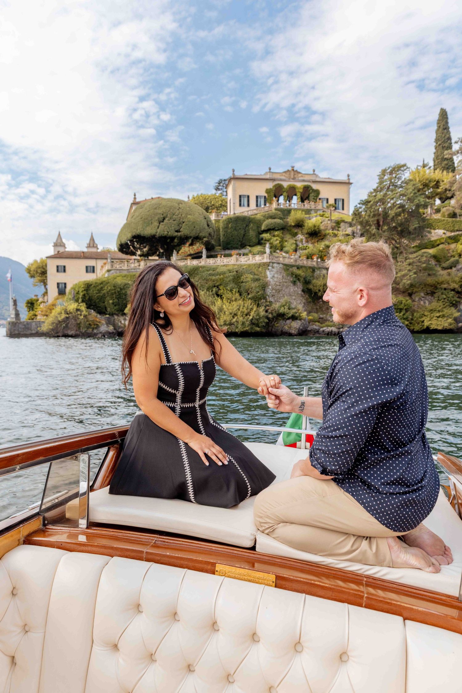 Special moment captured on luxury boat ride with Mediterranean villa views.