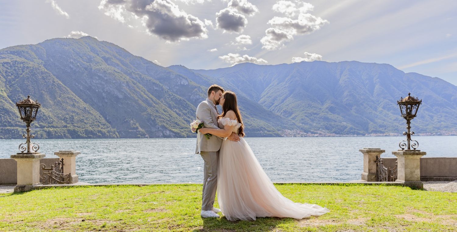 Scenic lakeside wedding portraits with dramatic mountain landscape in the background.