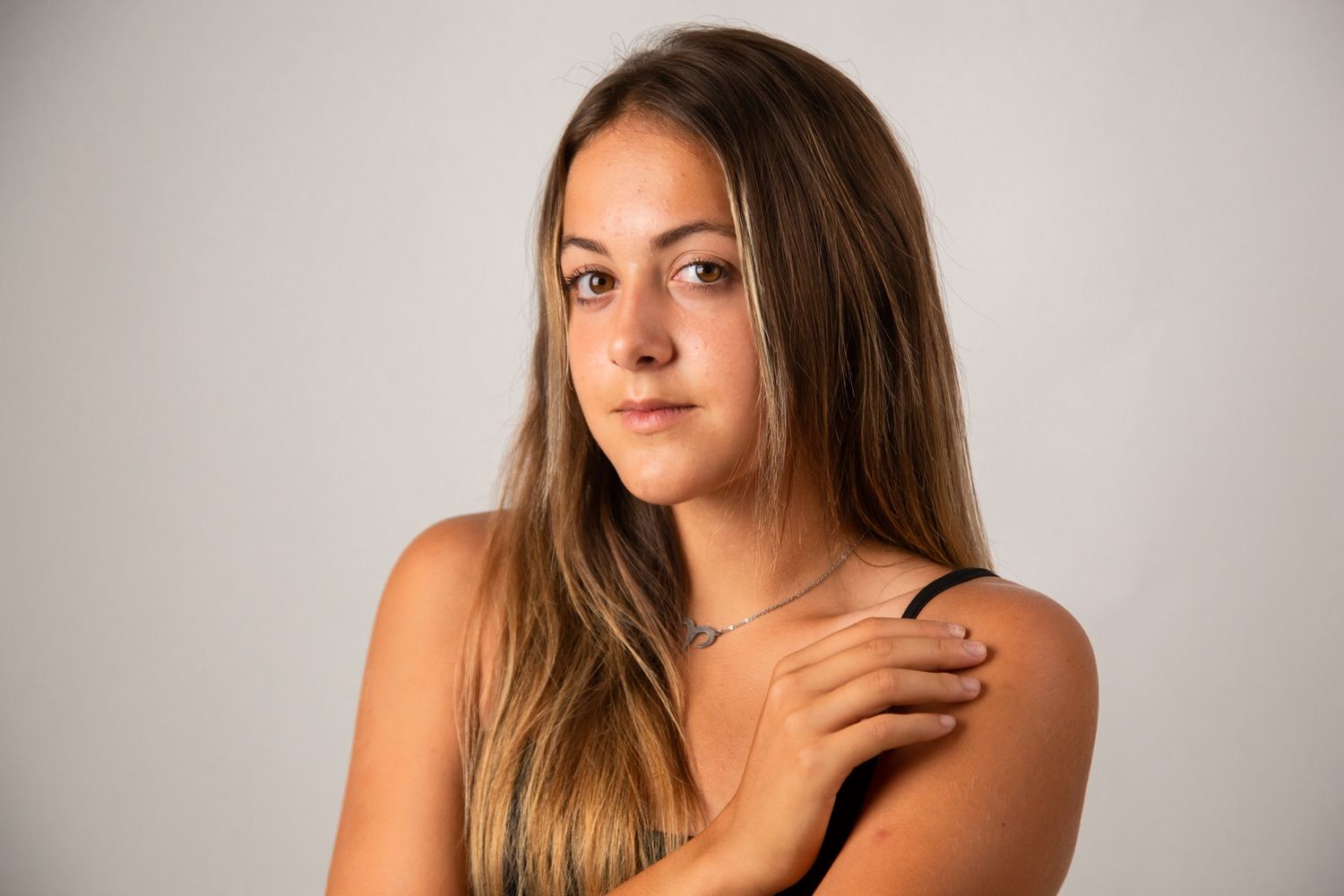 Studio portraits showing natural expressions and casual poses against light background.