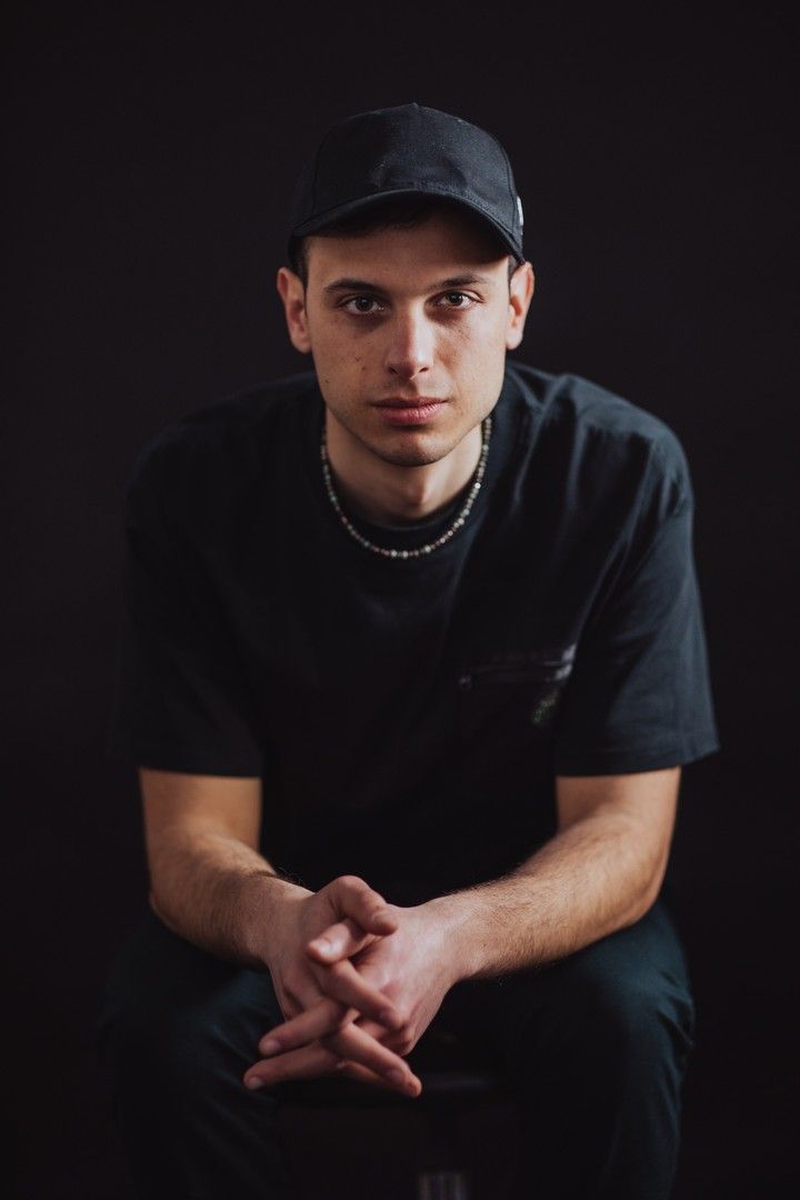 Artistic portrait series showing different poses in dark lighting with dramatic shadows.
