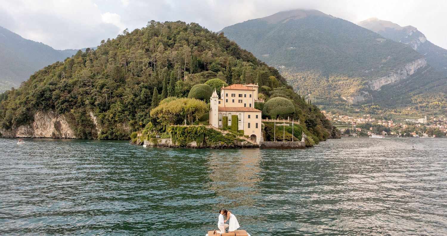 Scenic mountain lake landscape with historic villa and distant peaks in Lake Como, Italy.
