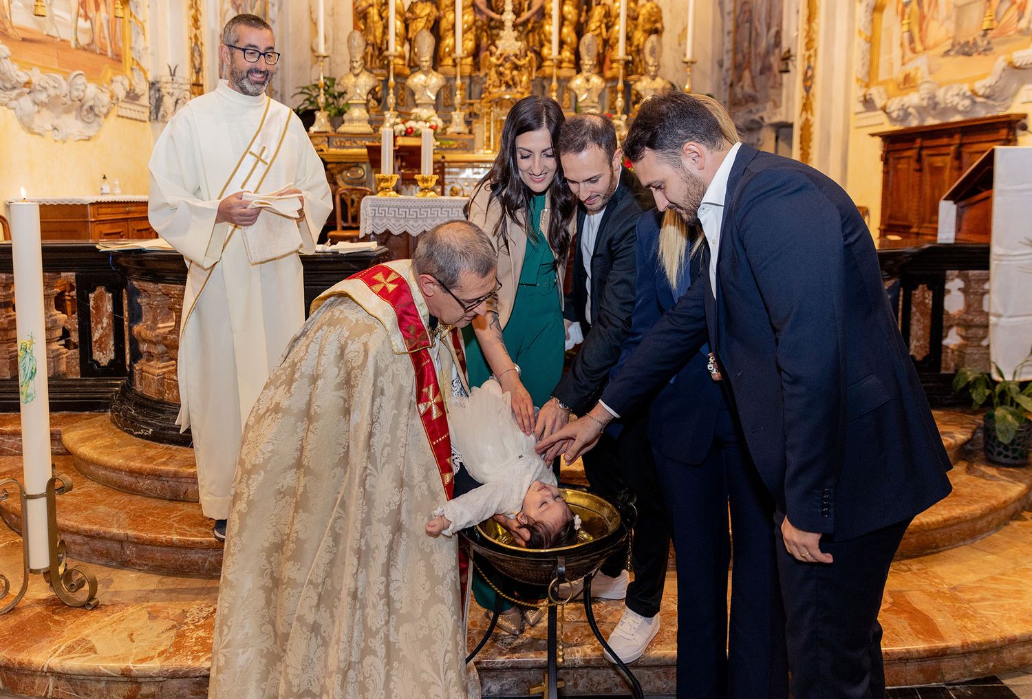 Religious ceremony taking place in ornate baroque church interior.