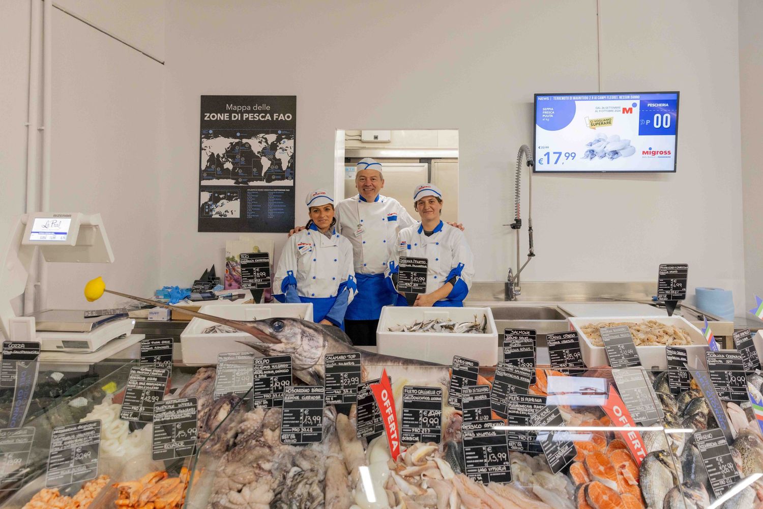 Retail seafood counter with fresh fish and seafood on ice display.