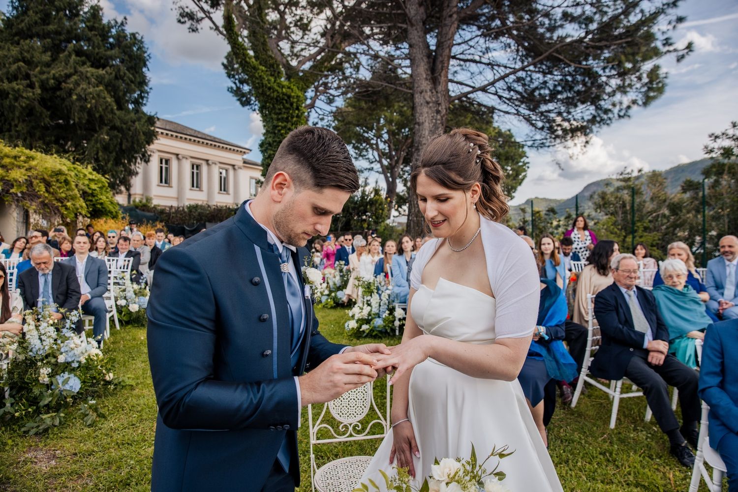 A joyful wedding ceremony moment with guests celebrating in a scenic outdoor setting.