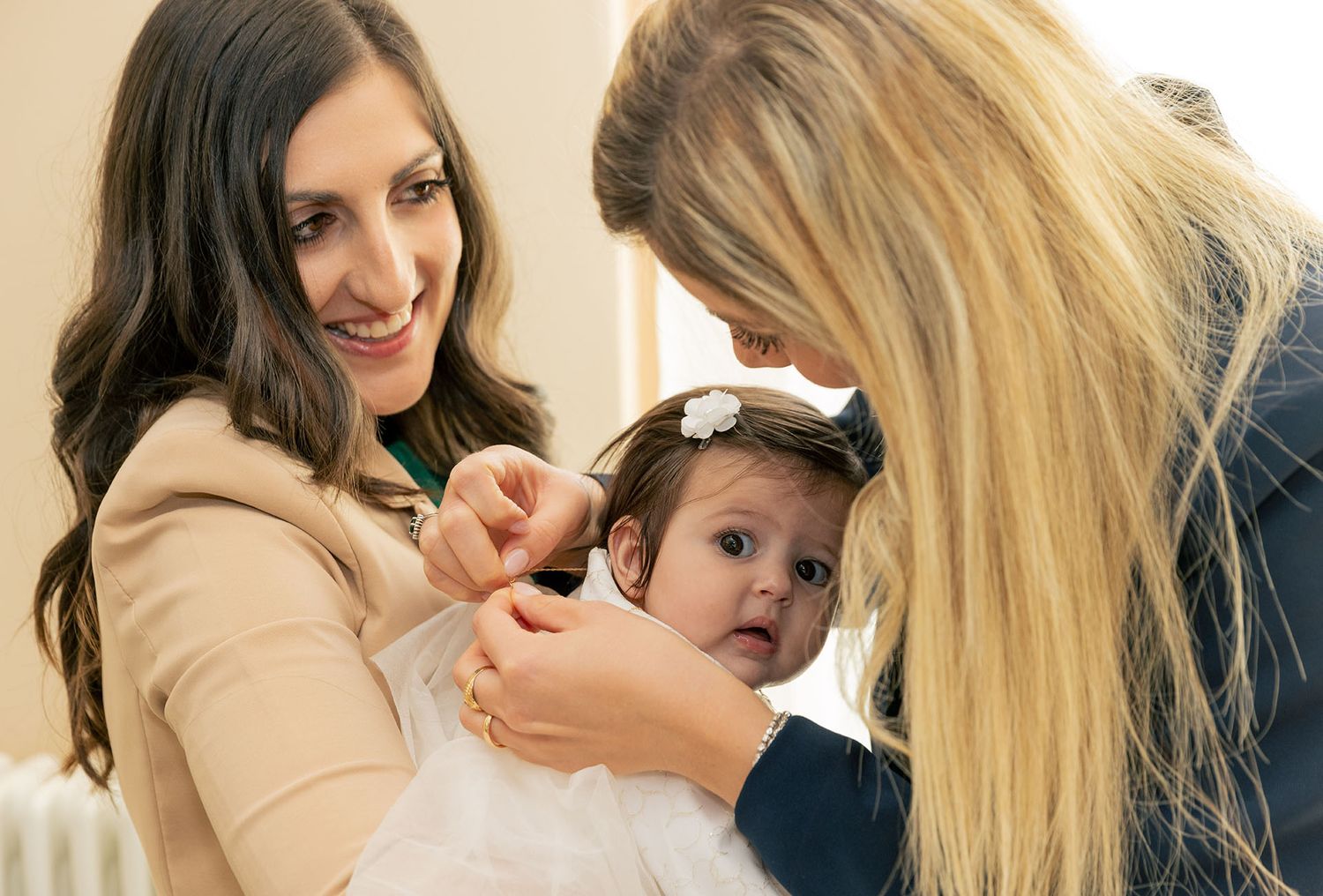 Tender moment during baby care with soft natural lighting.