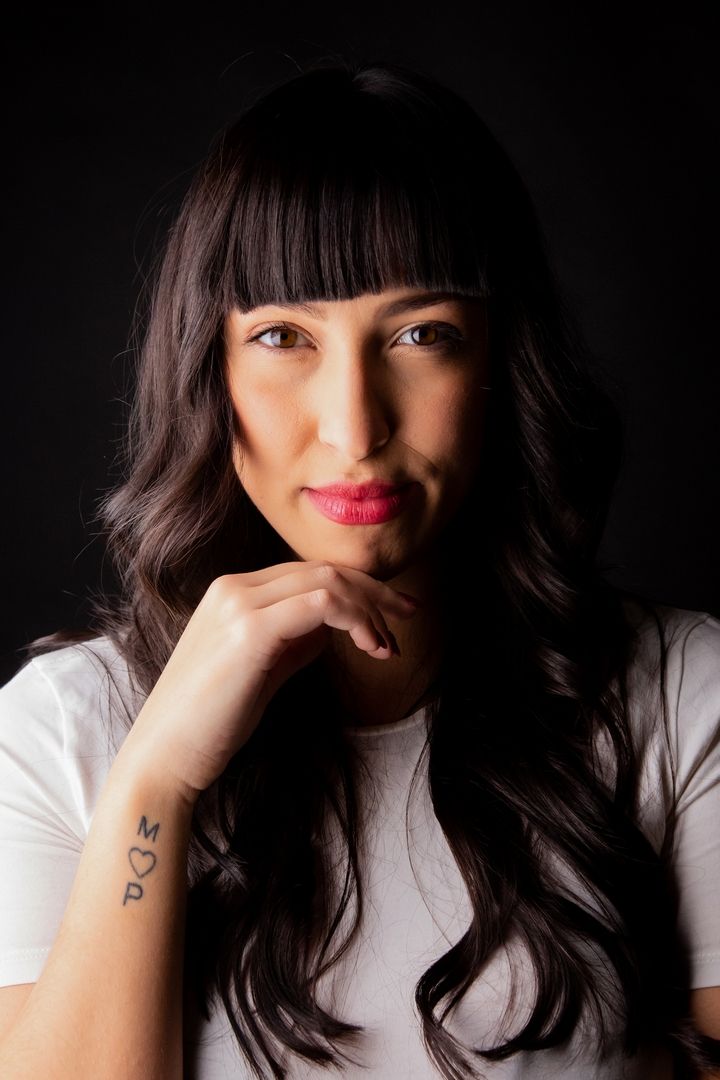 Moody portrait series featuring dark hair and bright lipstick against black background.