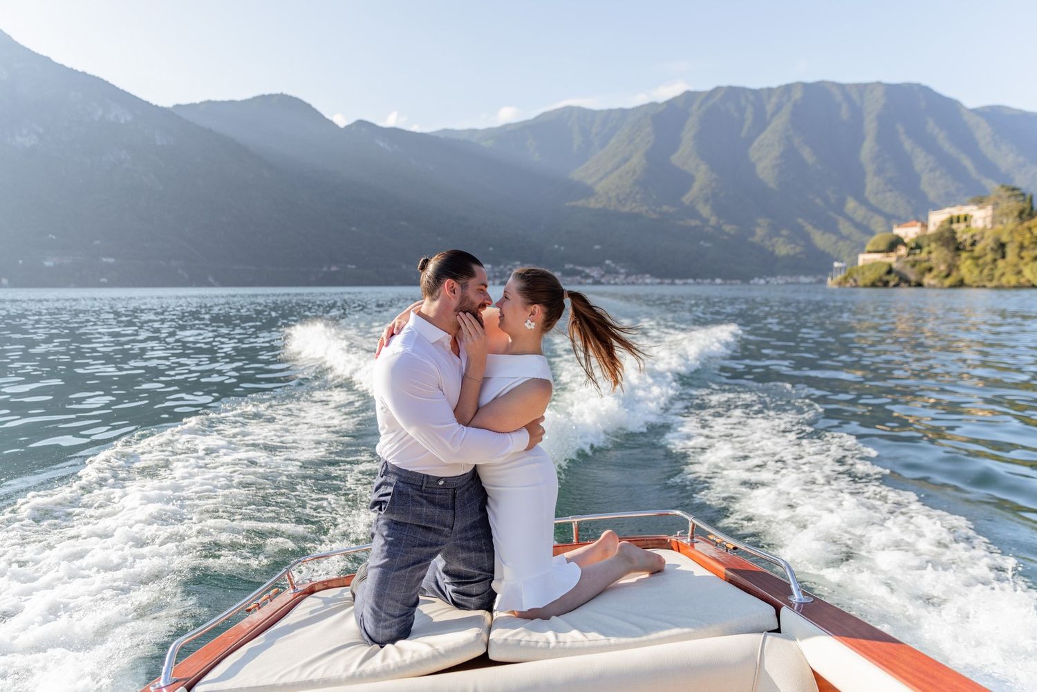 Romantic boat ride along a scenic mountain lake with crystal clear waters and lush shoreline.
