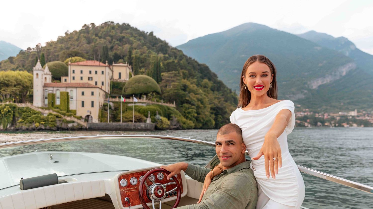A scenic boat tour along Lake Como's shoreline with historic villas and mountains in the background.