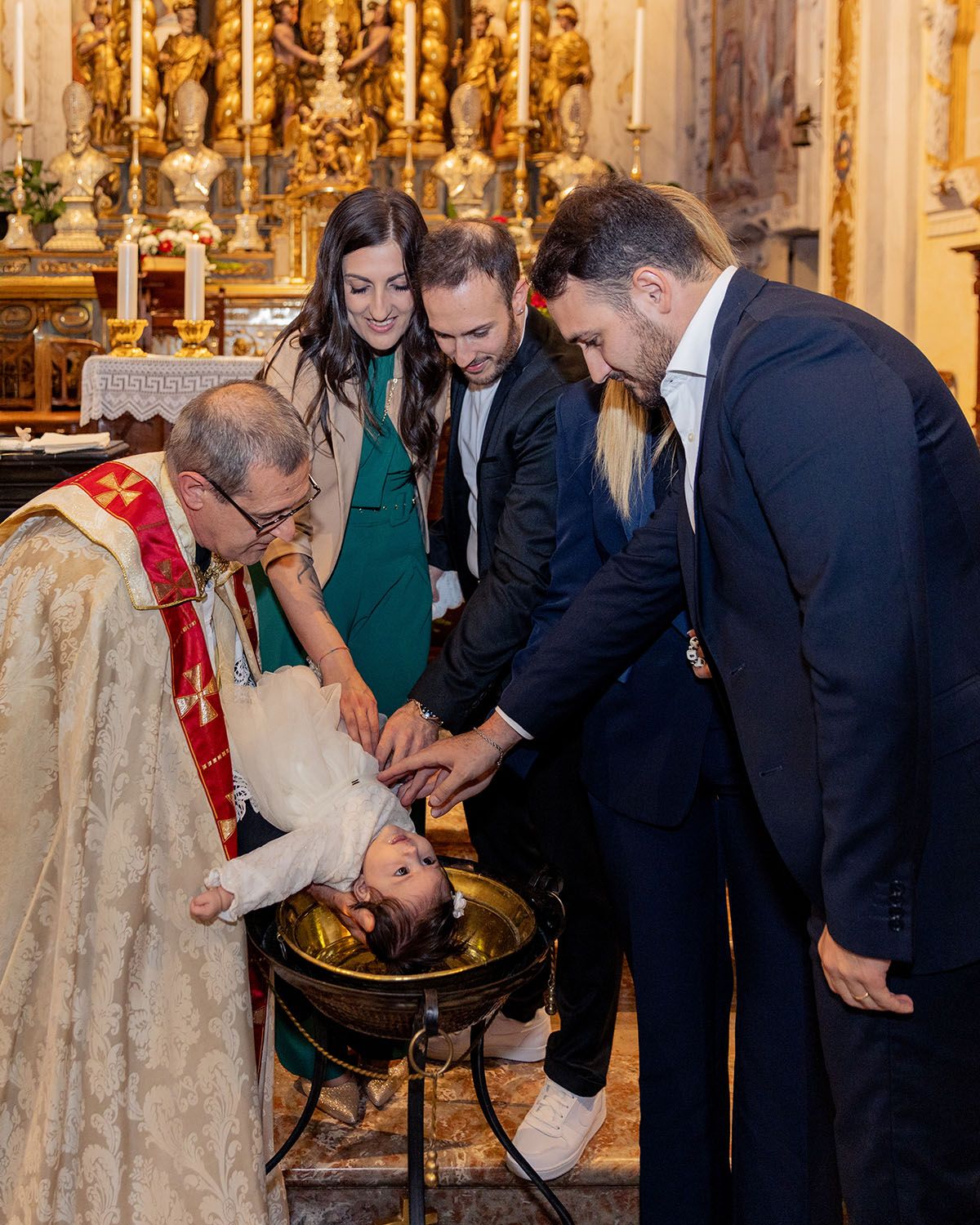 Religious ceremony taking place in ornate golden church interior.