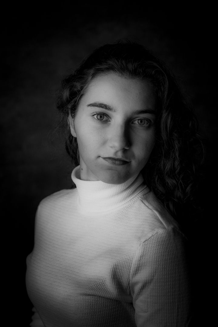 Dramatic black and white portraits in white turtleneck sweater.