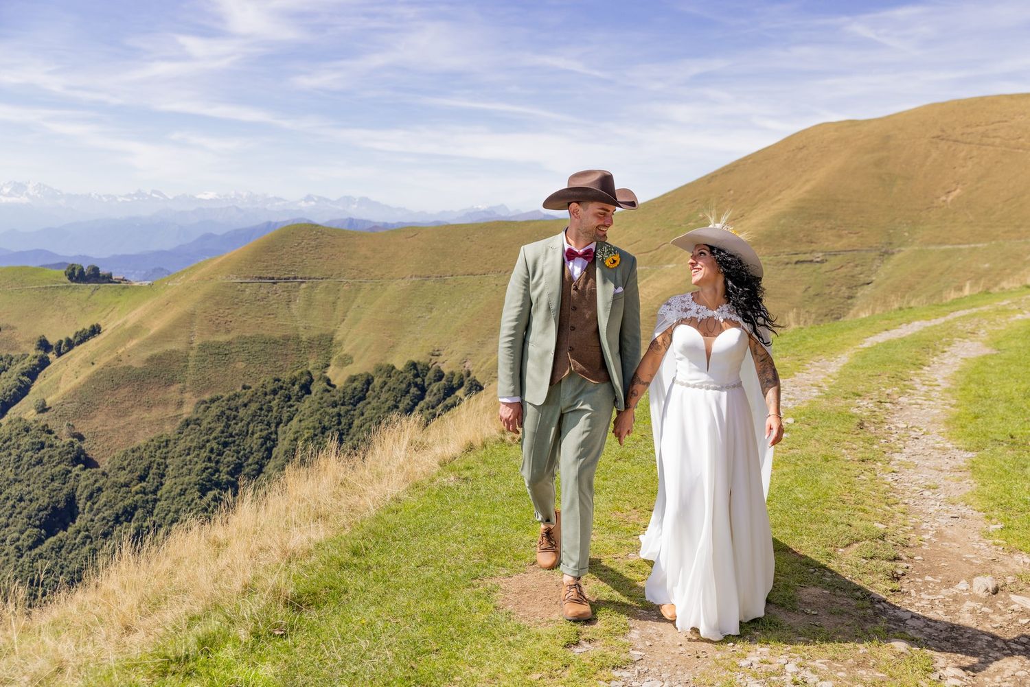 Newlyweds walking along mountain paths during their wedding photo session.