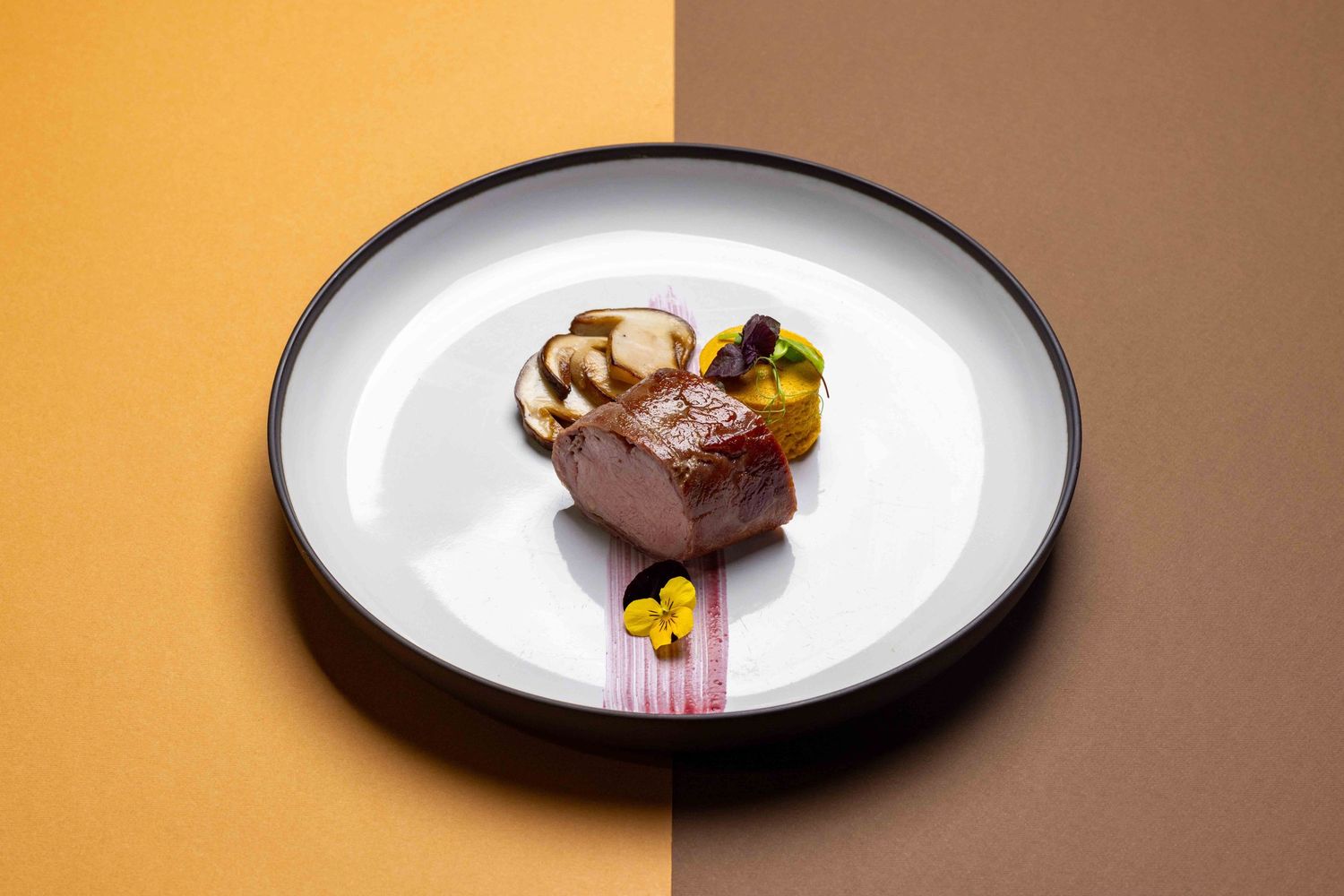 Sequence of elegant plated desserts on white dishes against warm orange background.